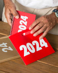 OCTÀGON DESIGN | 2024 Vinçon Desk Calendar | Minimalist desk calendar, red cover and white typography