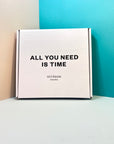 White clock box with "All you need is time" print black colour.