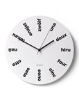 "Babel" wall clock. White base, typography and clock hands black colour.