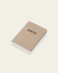 "Write" notebook on a white background. | Cuaderno "Write" sobre una superfície blanca. | Llibreta "Write" sobre una superfície blanca.