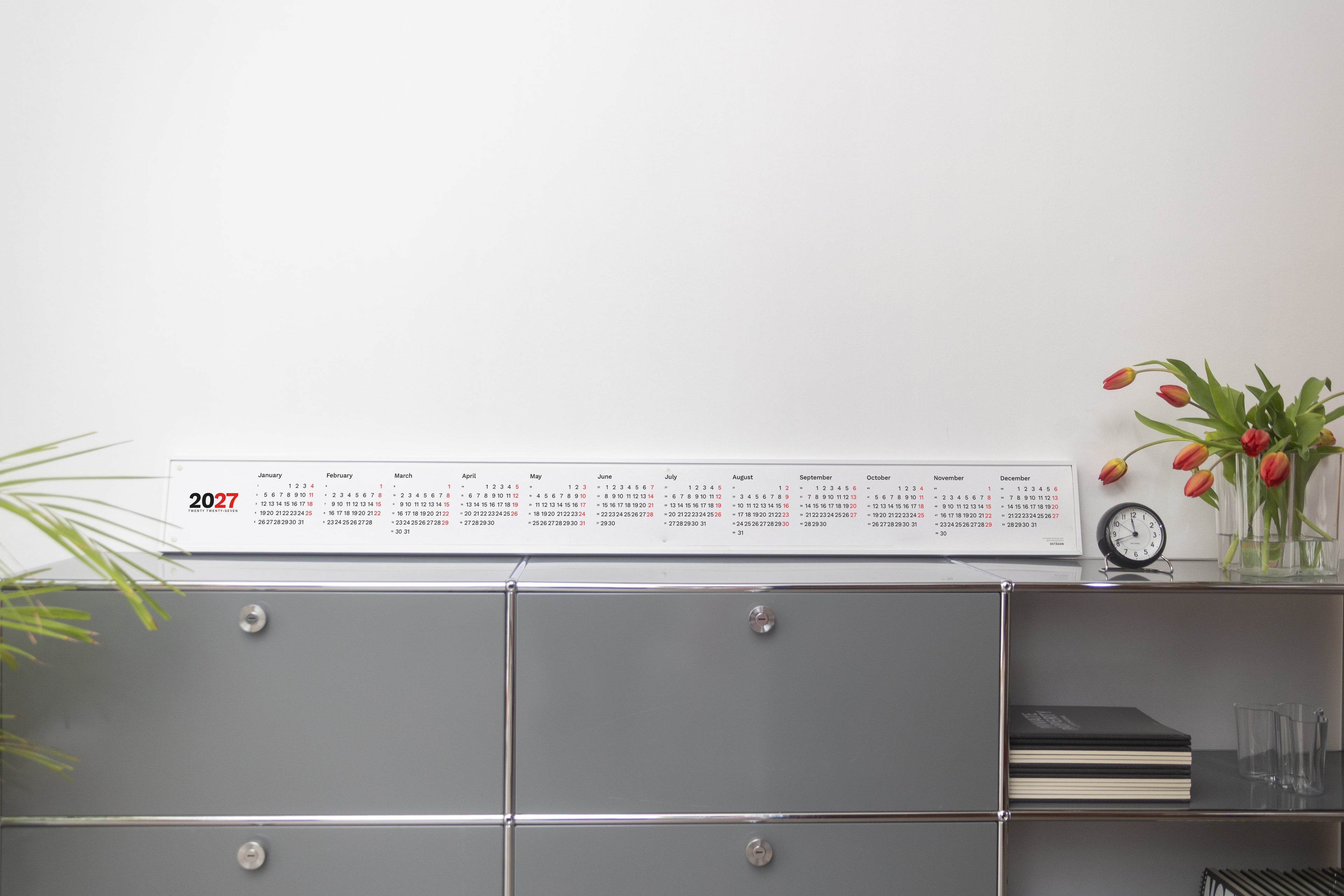 2027 Horizontal Calendar by Octàgon Design. The calendar placed on top of a piece of USM furniture.