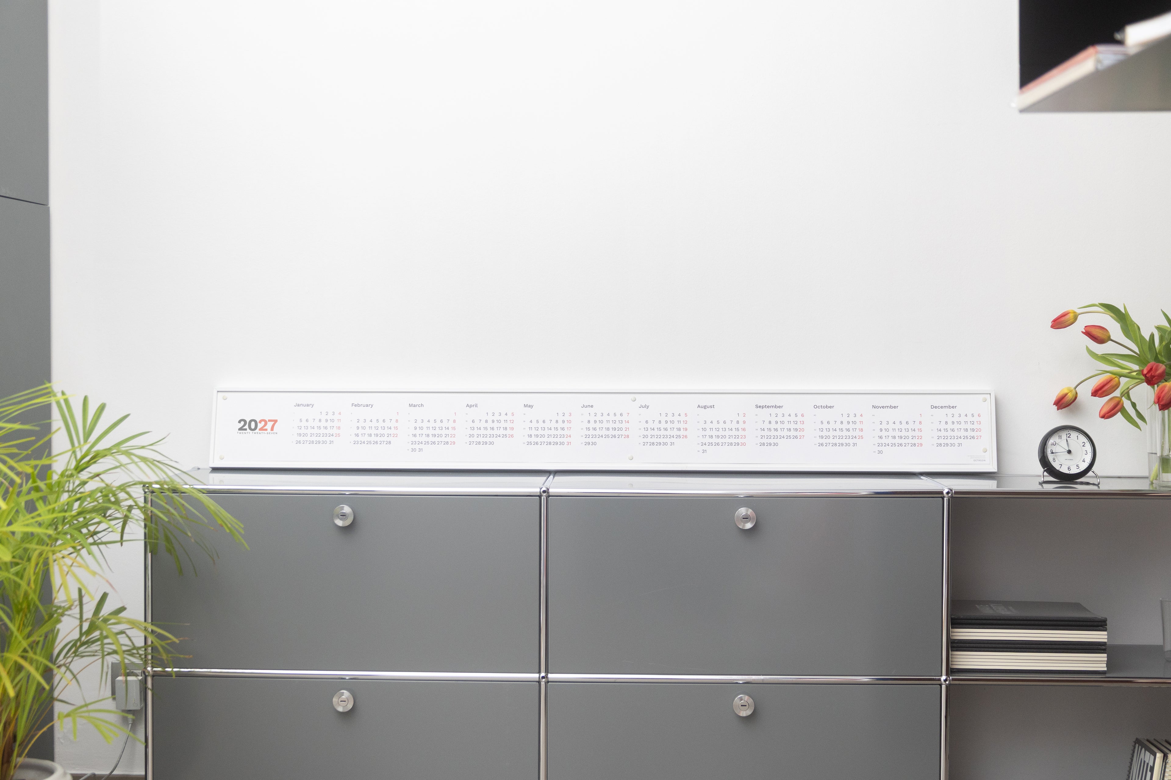 2027 Horizontal Calendar by Octàgon Design. The calendar placed on top of a piece of USM furniture.