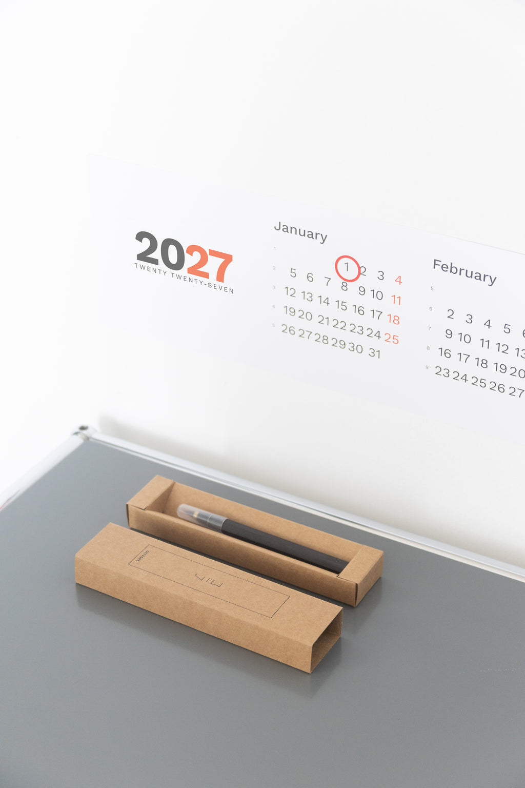 2027 Horizontal Calendar by Octàgon Design. The calendar placed on top of a piece of USM furniture.