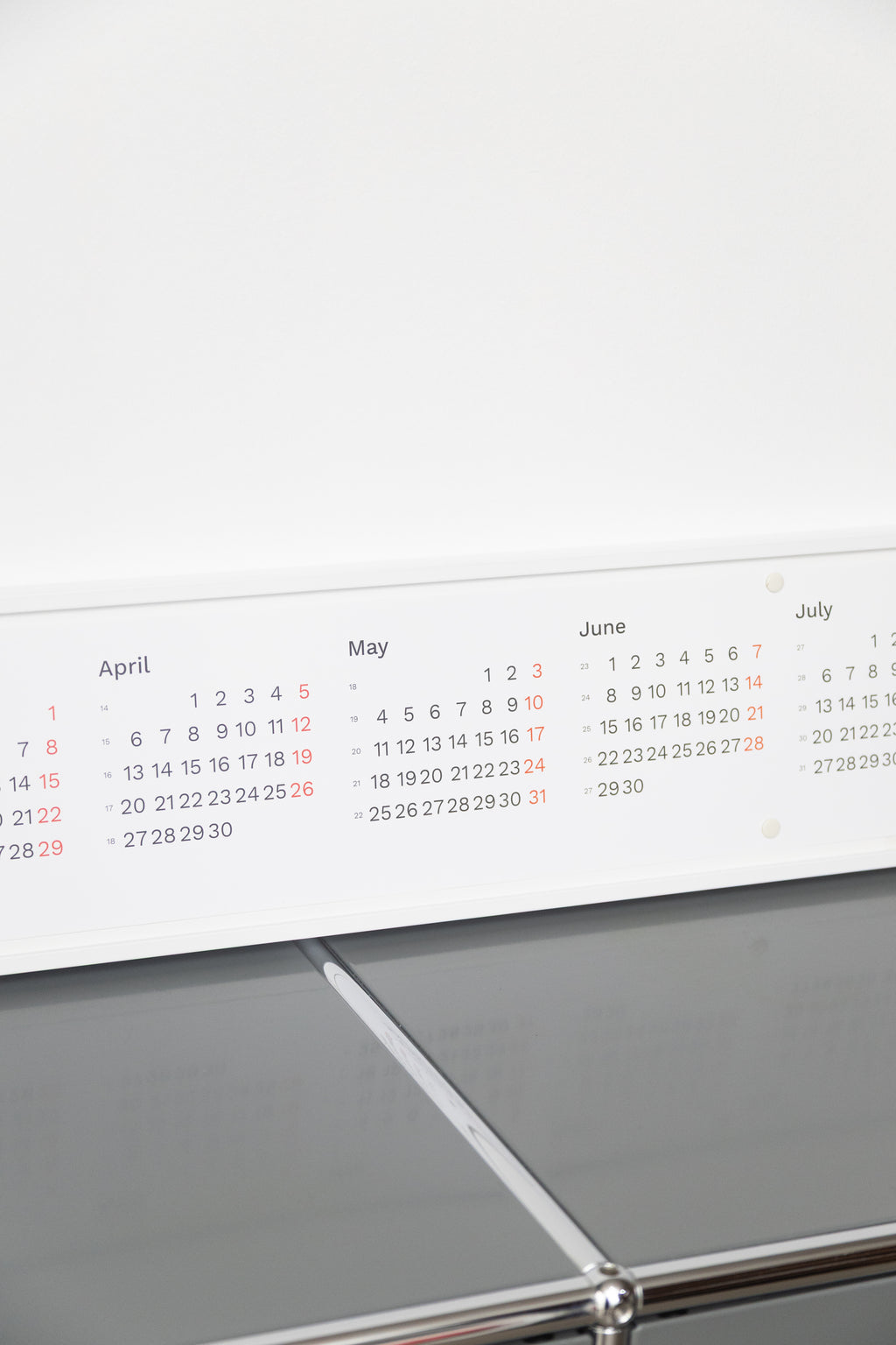 2027 Horizontal Calendar by Octàgon Design. The calendar placed on top of a piece of USM furniture.