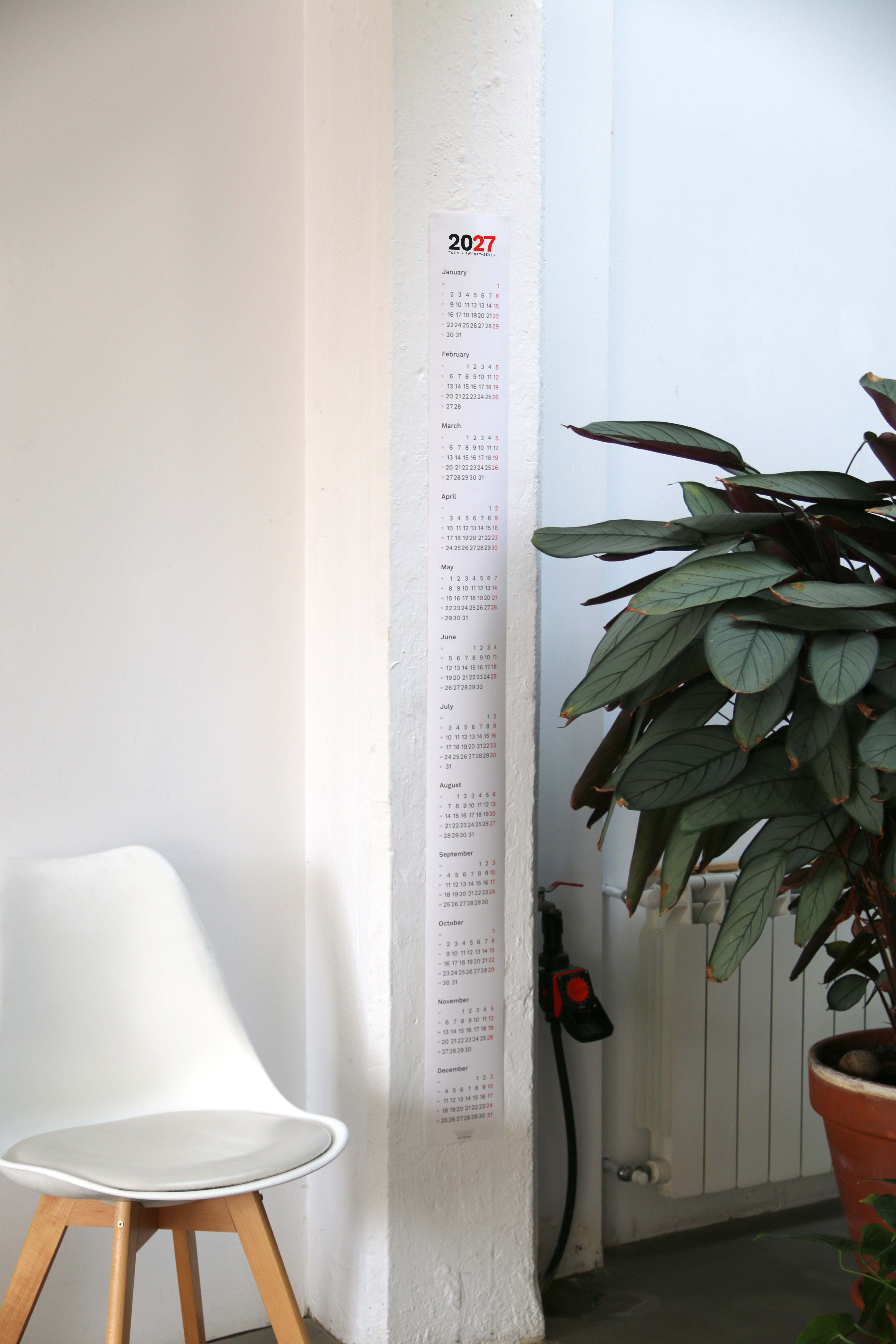 2027 Vertical Calendar by Octàgon Design. The calendar placed in a home atmosphere.