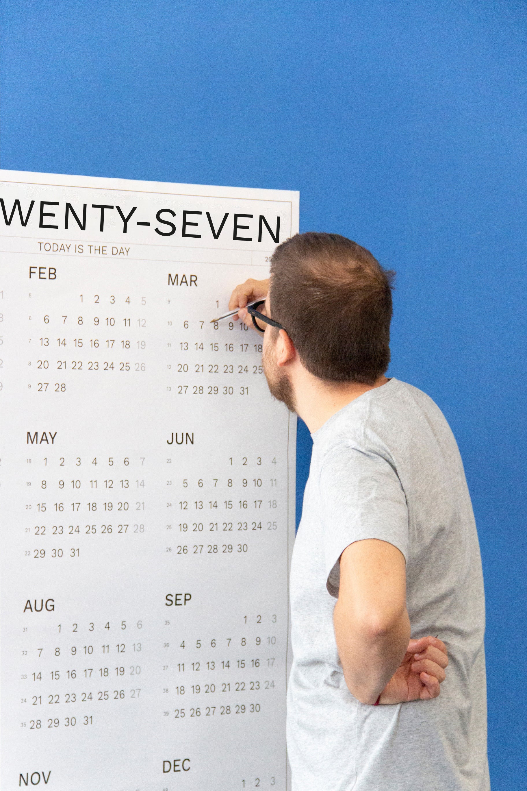 2027 Wall Calendar by Octàgon Design. Date Markers. A man planning and organizing events.