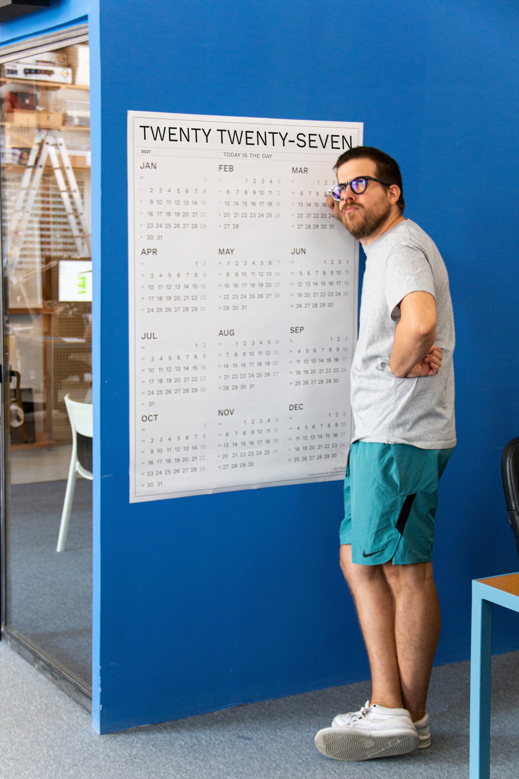 2027 Wall Calendar by Octàgon Design. Date Markers. A man planning and organizing events.