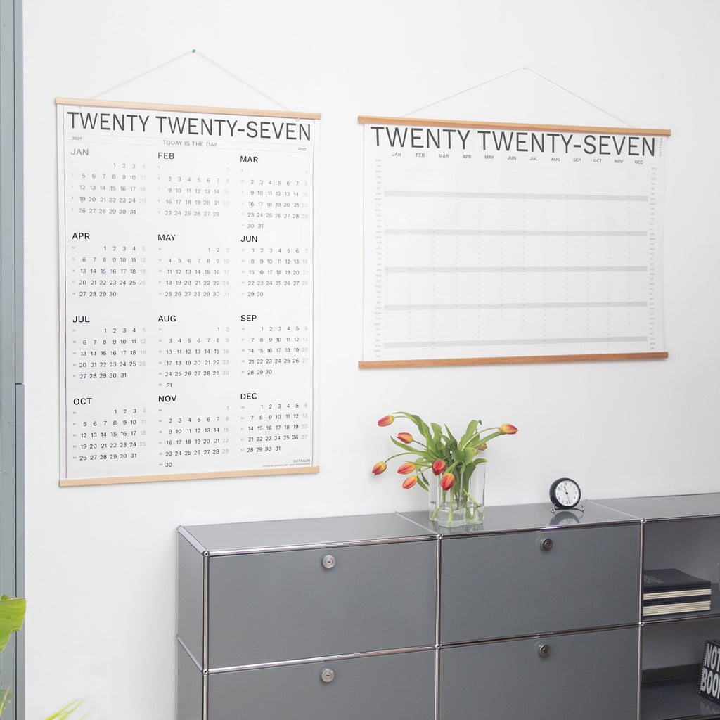 2027 Wall Calendar and 2027 Year Plan by Octàgon Design hanging on a white wall. Office Atmosphere.