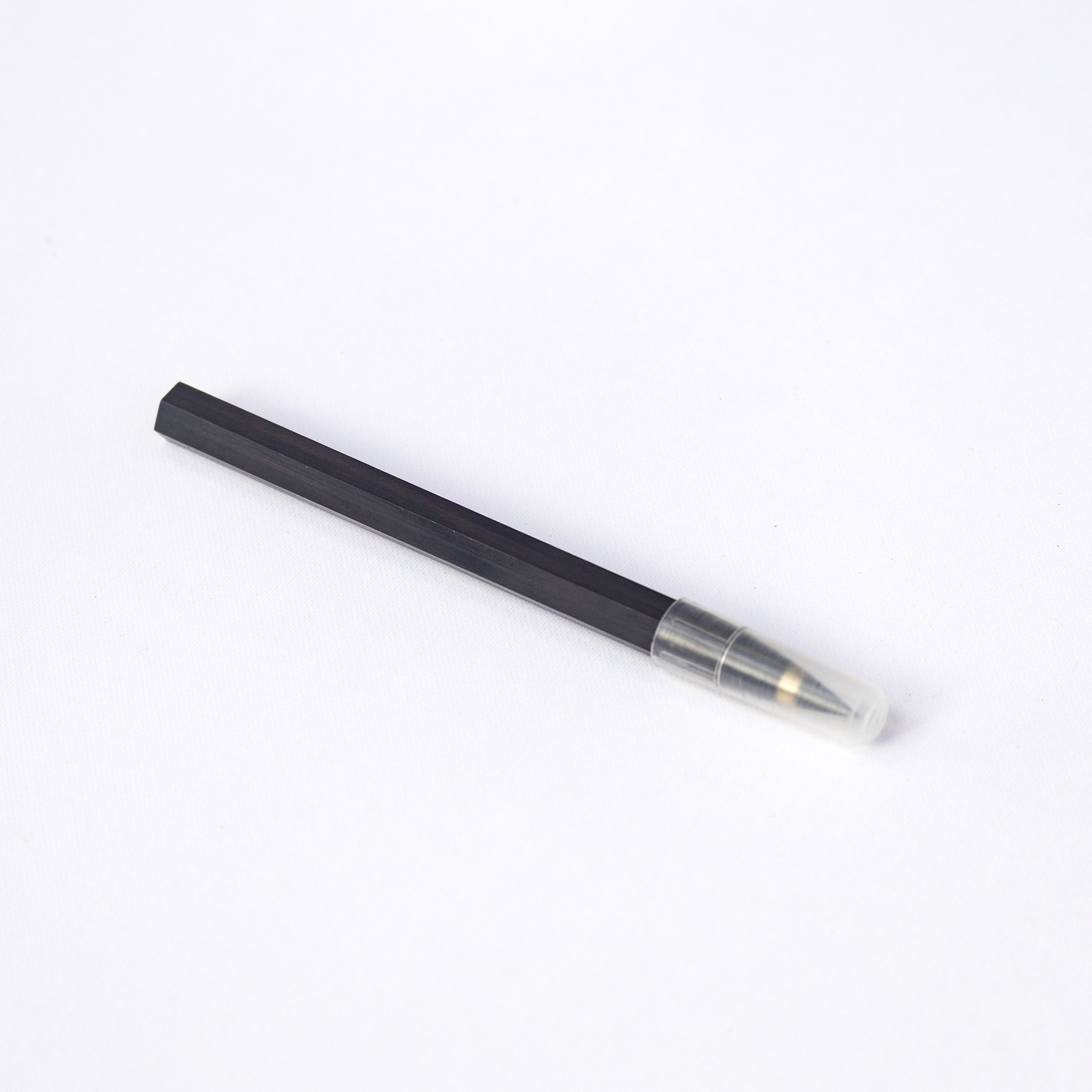 Octàgon Eternal Pencil on a white notepad with handwritten text on a white background