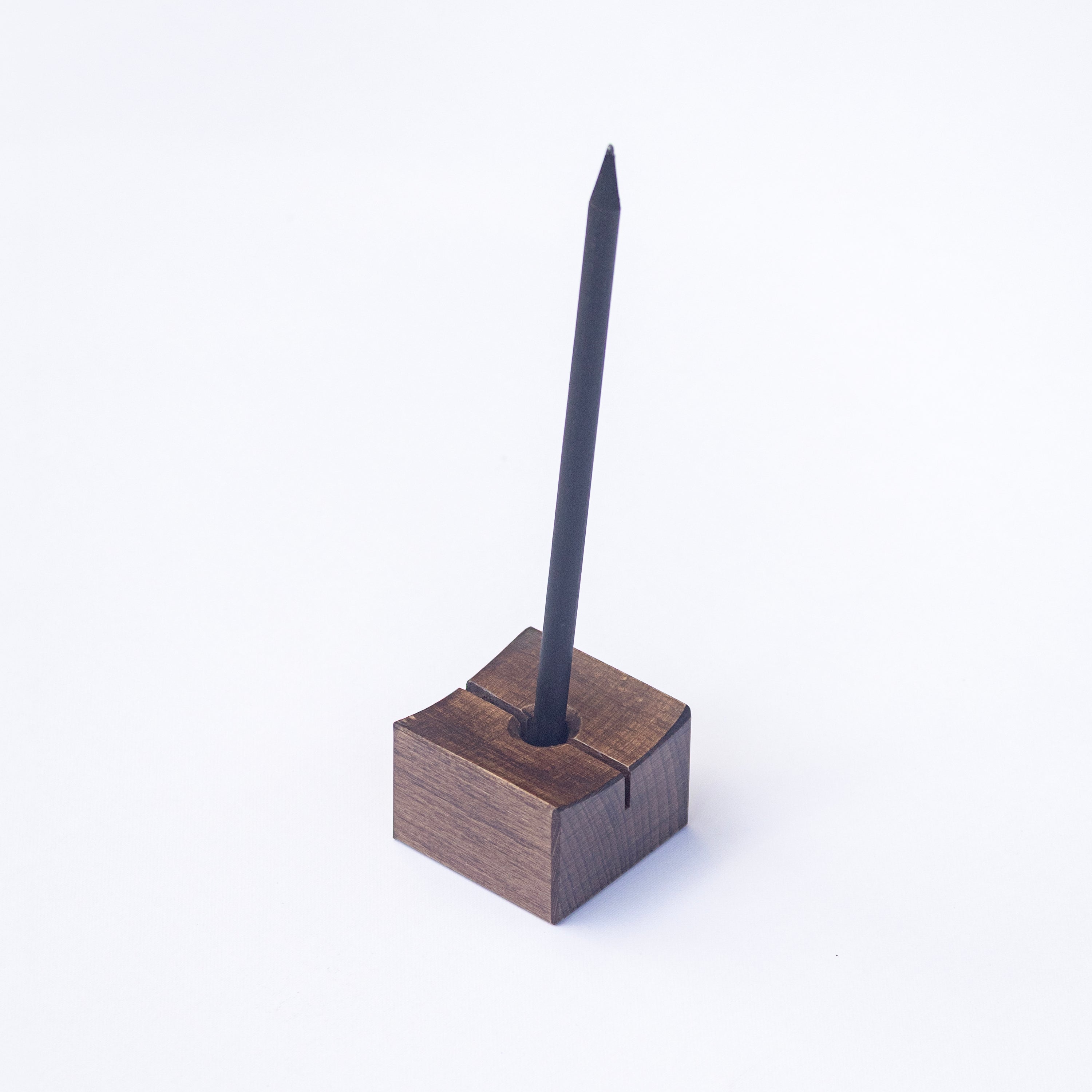 Min Point wooden pen holder with a black pen on a white background