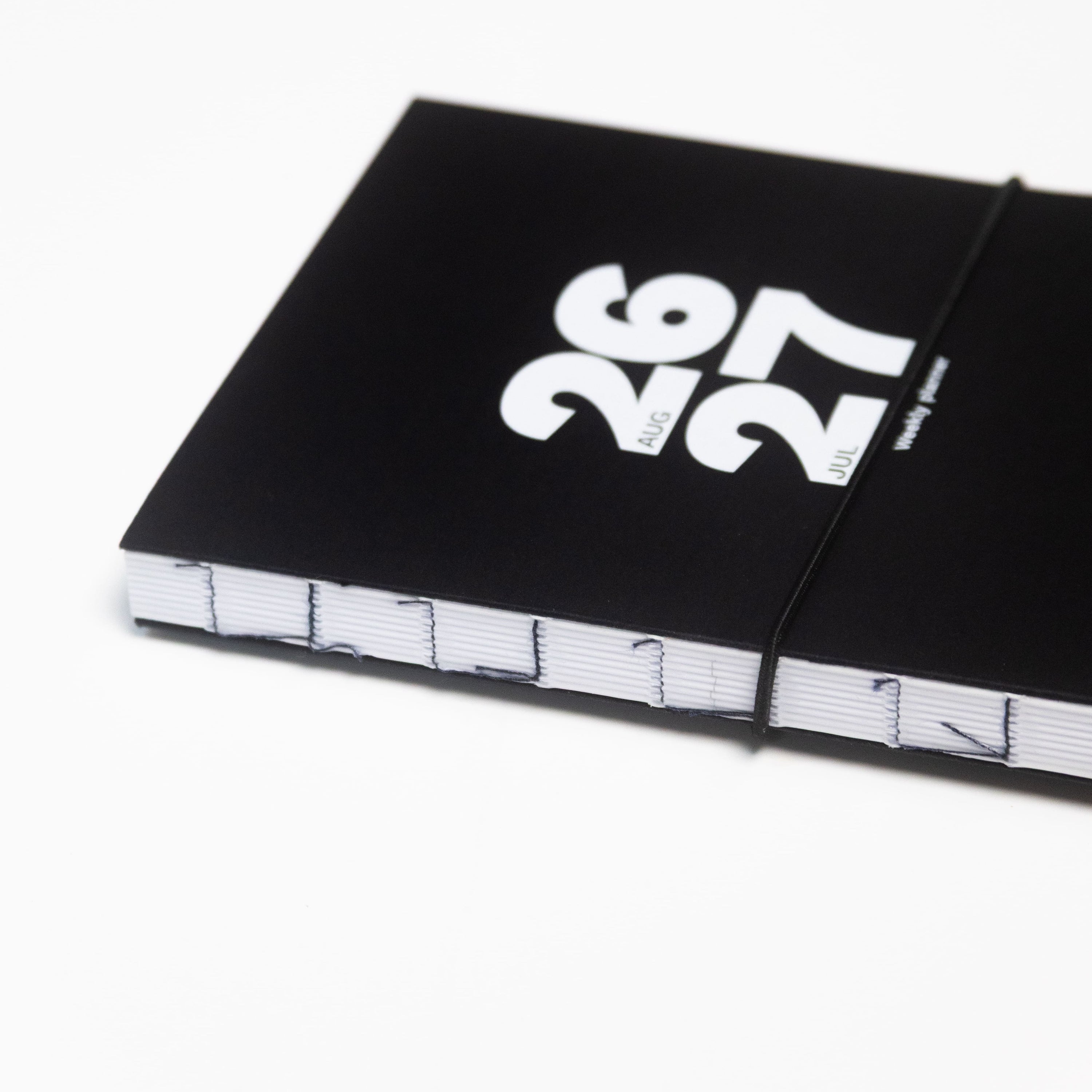 2026-2027 Academic Weekly Planner black with exposed spine and elastic band - Octàgon Design