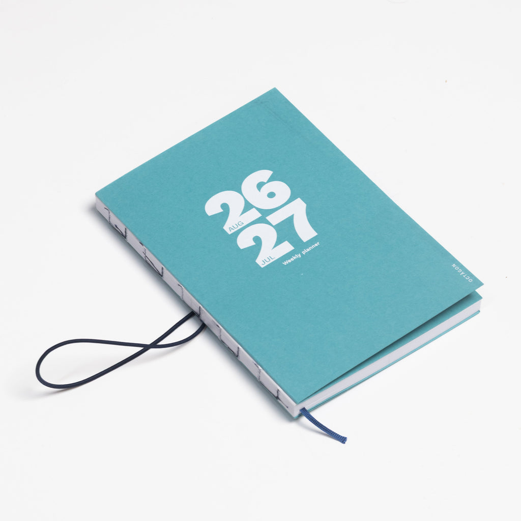 2026-2027 Academic Weekly Planner Caribbean Blue with exposed spine and elastic band - Octàgon Design