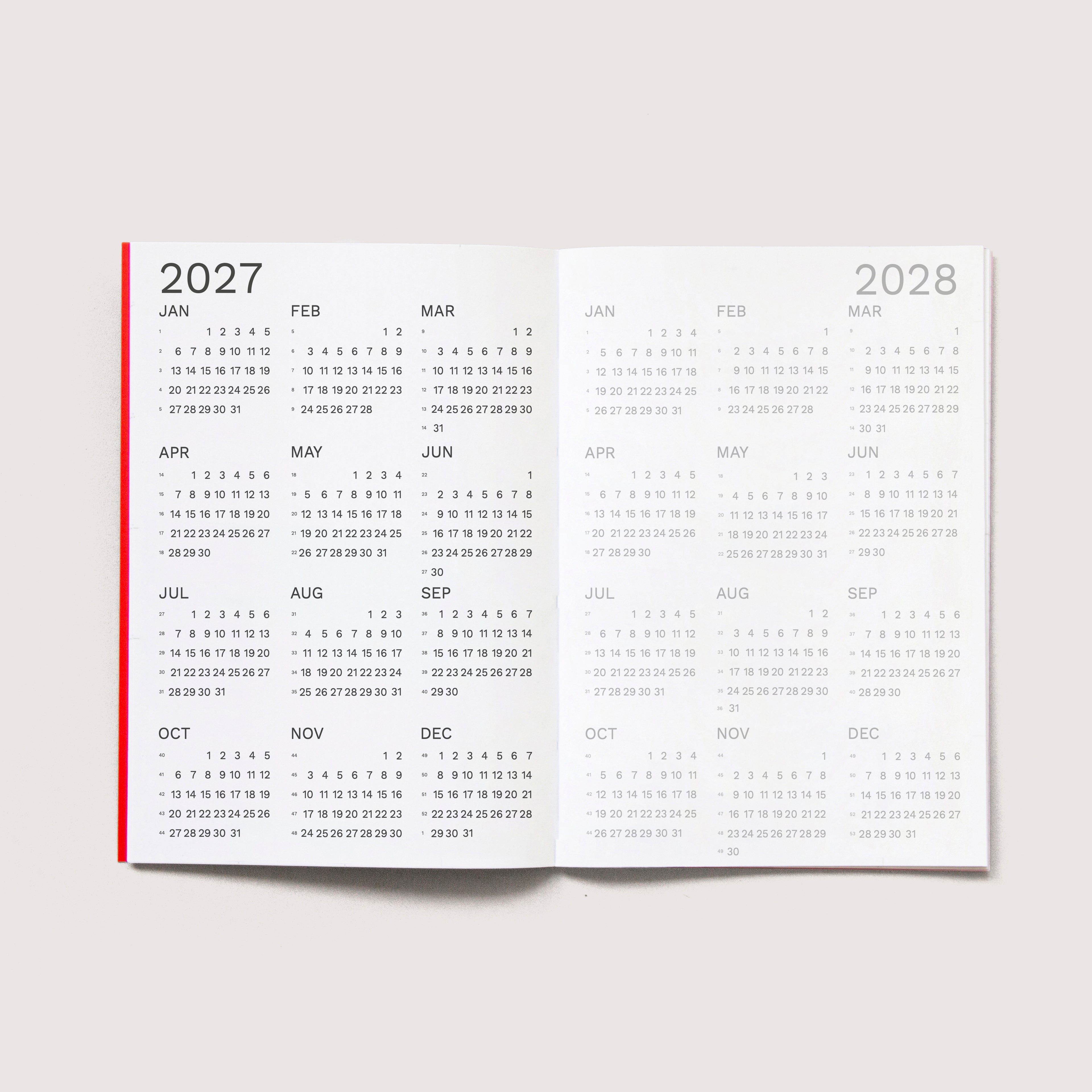 The iconic Mini Monthly Planner similar A6 size by Octàgon Design.  2027 and 2028 Calendars.
