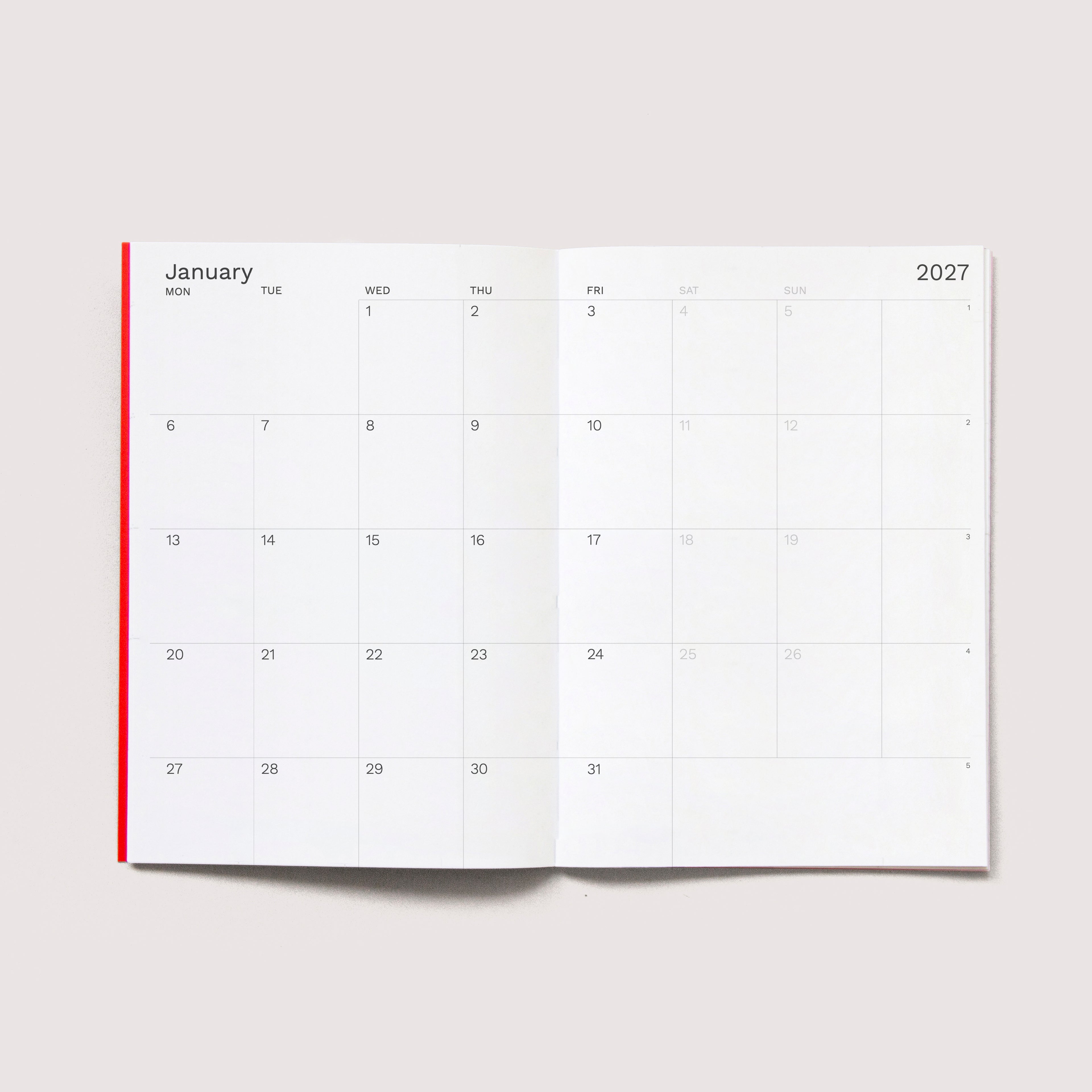 The iconic Mini Monthly Planner similar A6 size by Octàgon Design.  Monthly view.