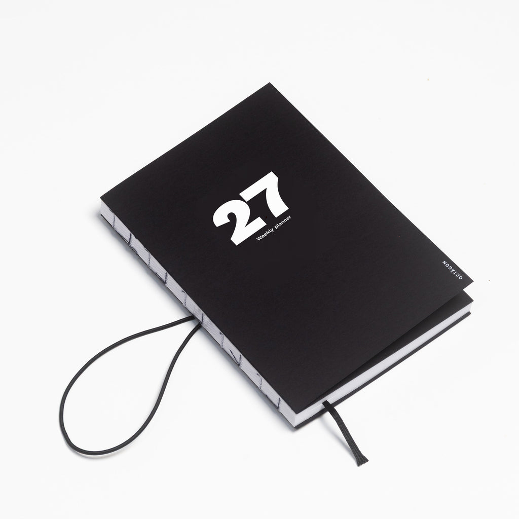 2027 Weekly Planner A5 by Octàgon Design. Black color. Elastic band detail.
