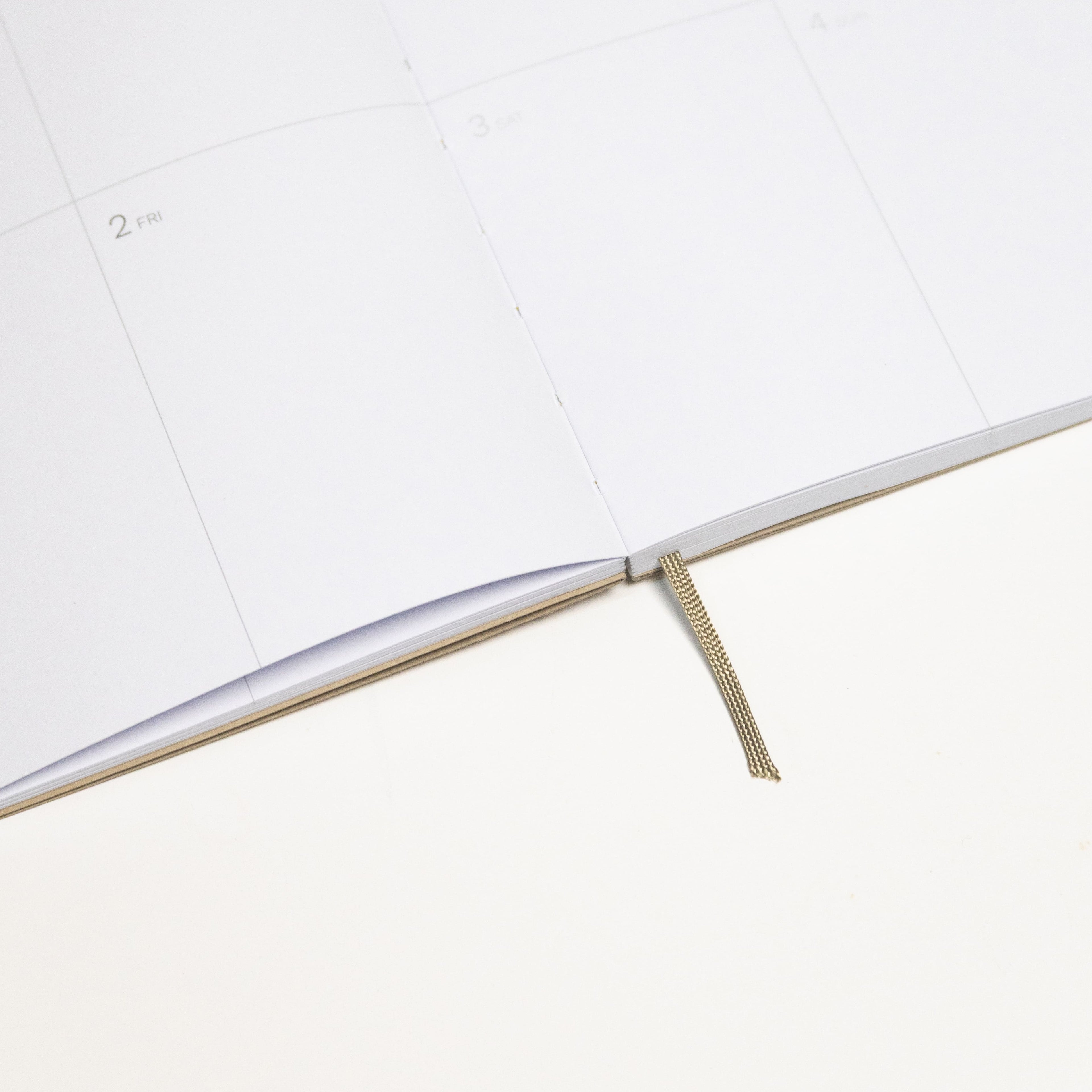 2027 Weekly Planner A5 by Octàgon Design. Camel color. Exposed spine detail.