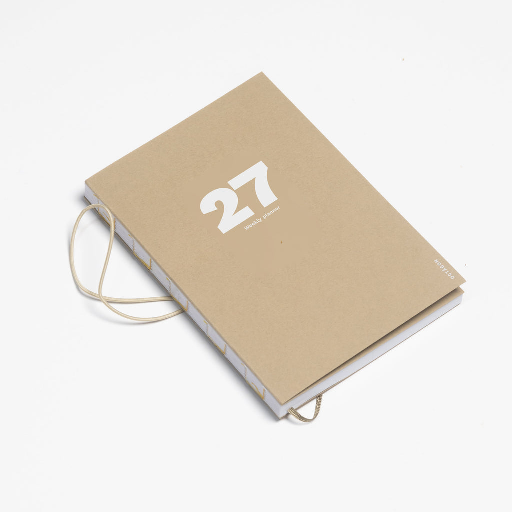 2027 Weekly Planner A5 by Octàgon Design. Camel color. Main cover, elastic band detail.