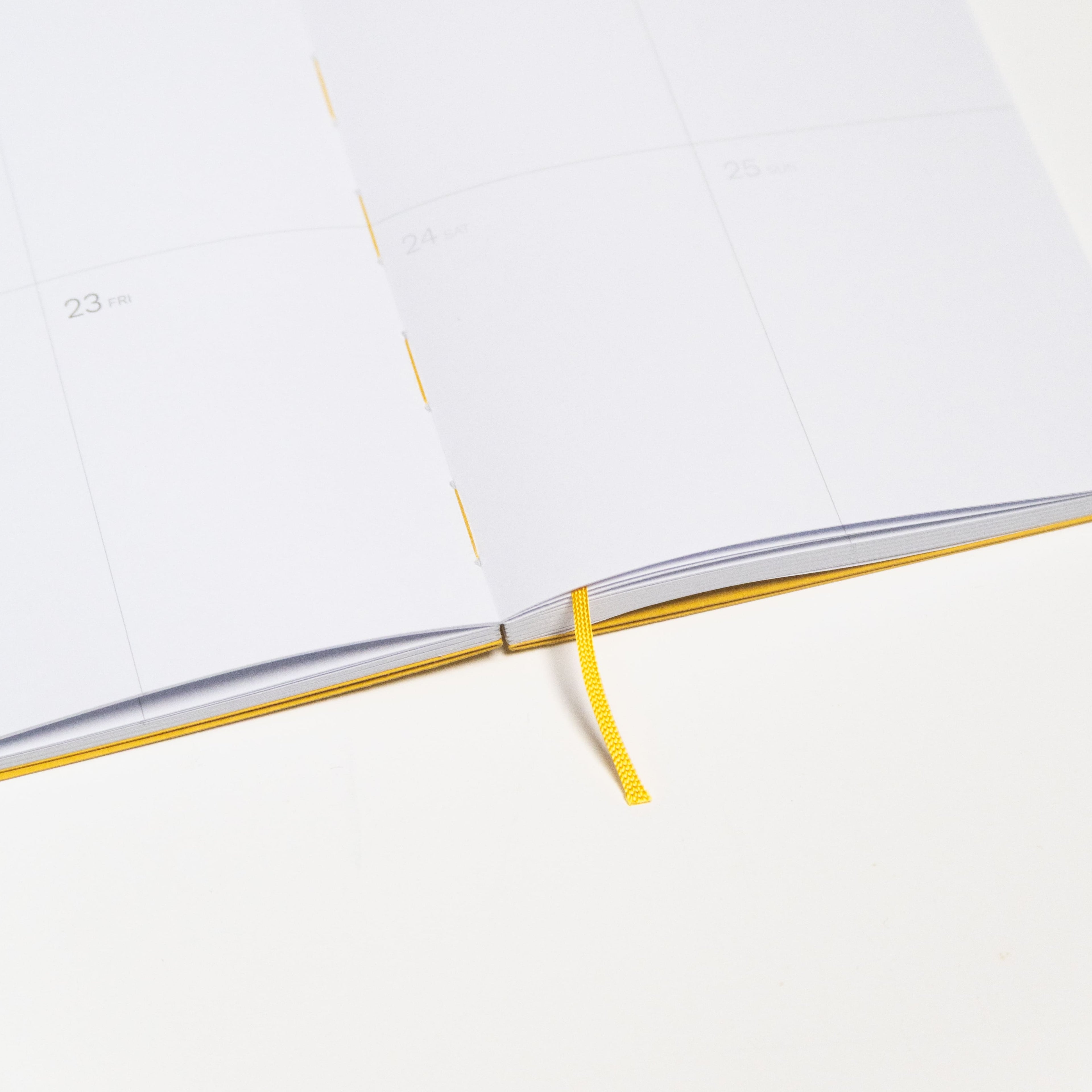 2027 Weekly Planner A5 by Octàgon Design. Yellow color. Exposed spine detail.