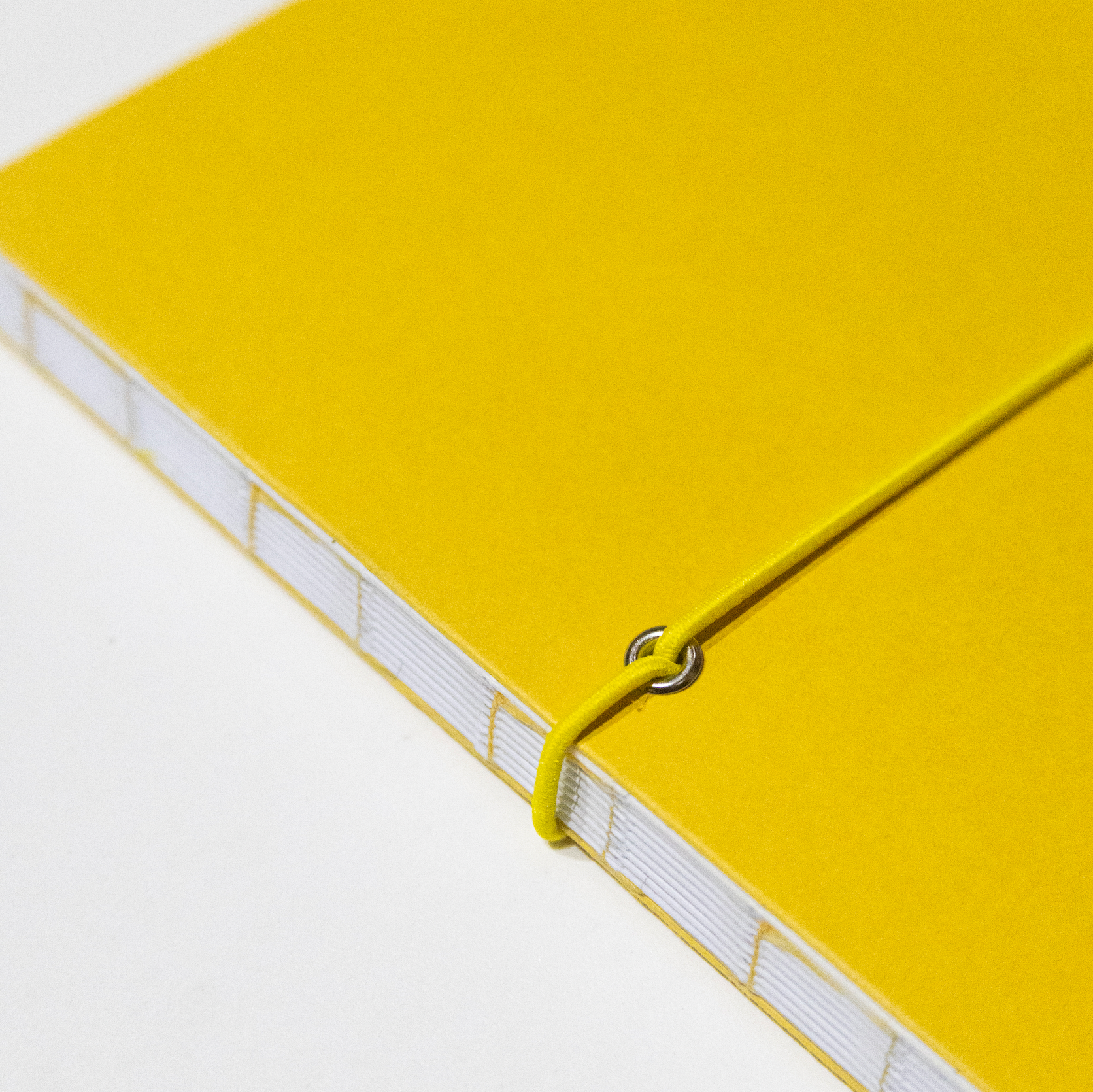 2027 Weekly Planner A5 by Octàgon Design. Yellow color. Exposed spine detail.