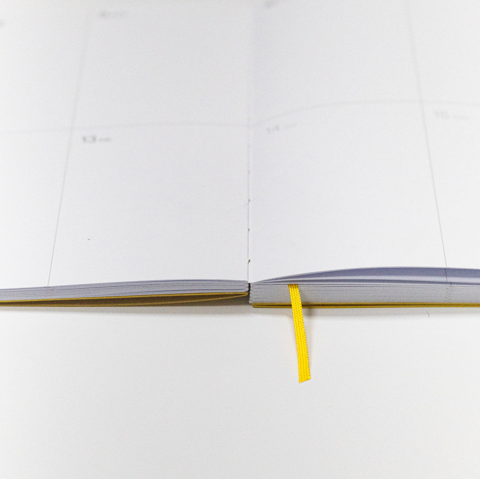 2027 Weekly Planner A5 by Octàgon Design. Yellow color. Exposed spine detail.