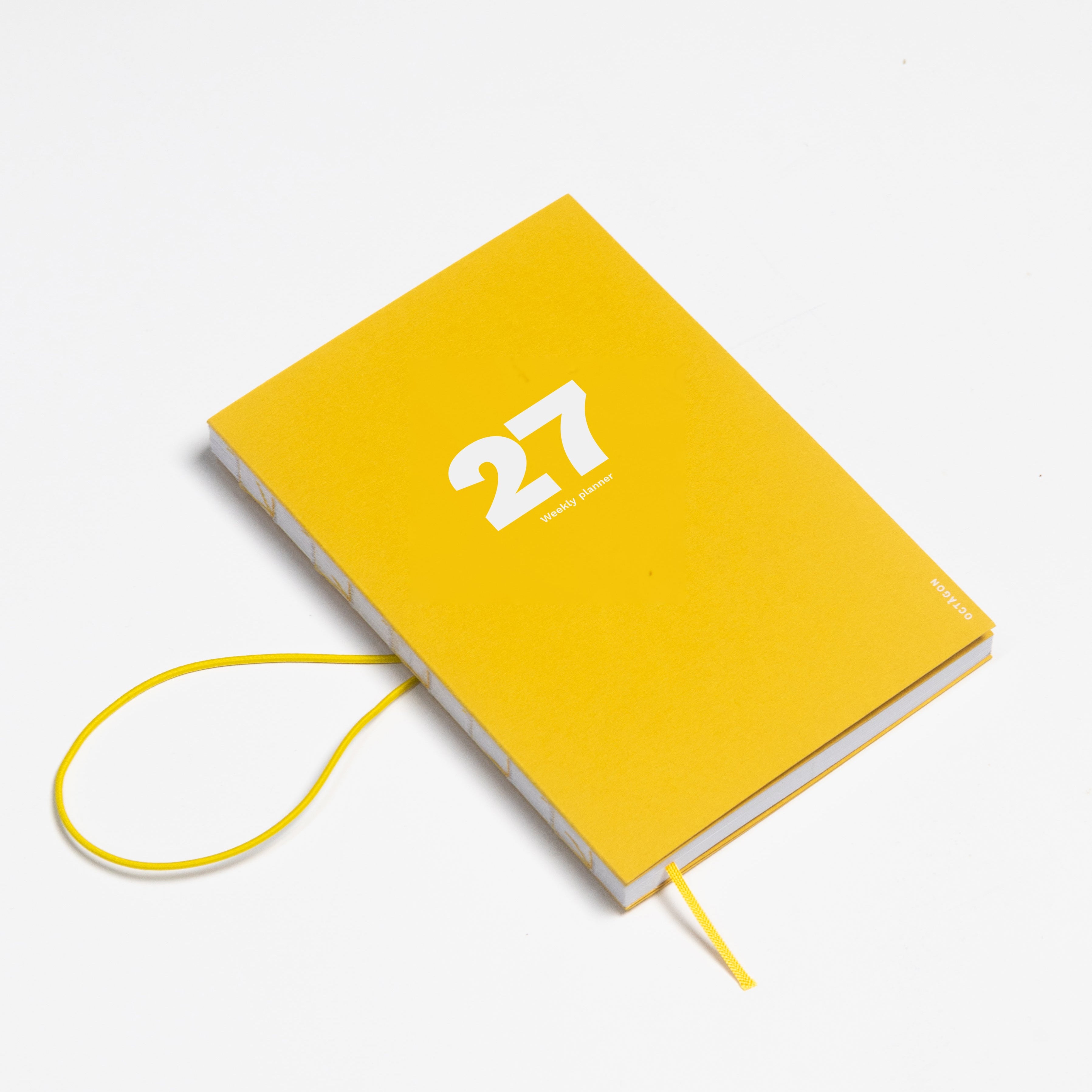 2027 Weekly Planner A5 by Octàgon Design. Indian Yellow color. Elastic band detail.