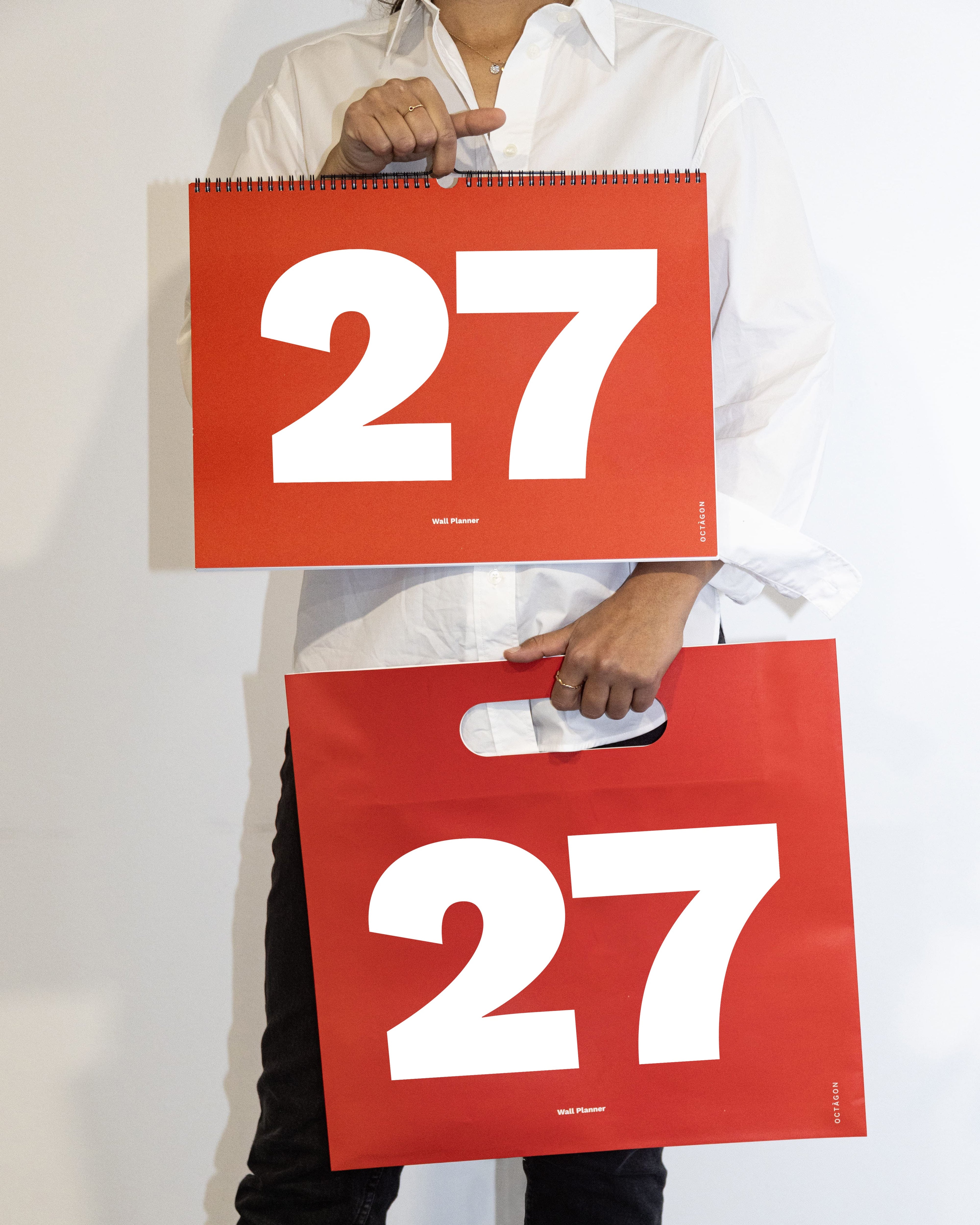 2027 Wall Planner by Octàgon Design. A girl showing the calendar and the bag.
