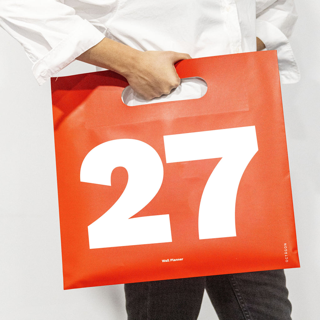 2027 Wall Planner by Octàgon Design. A girl with the calenar bag.