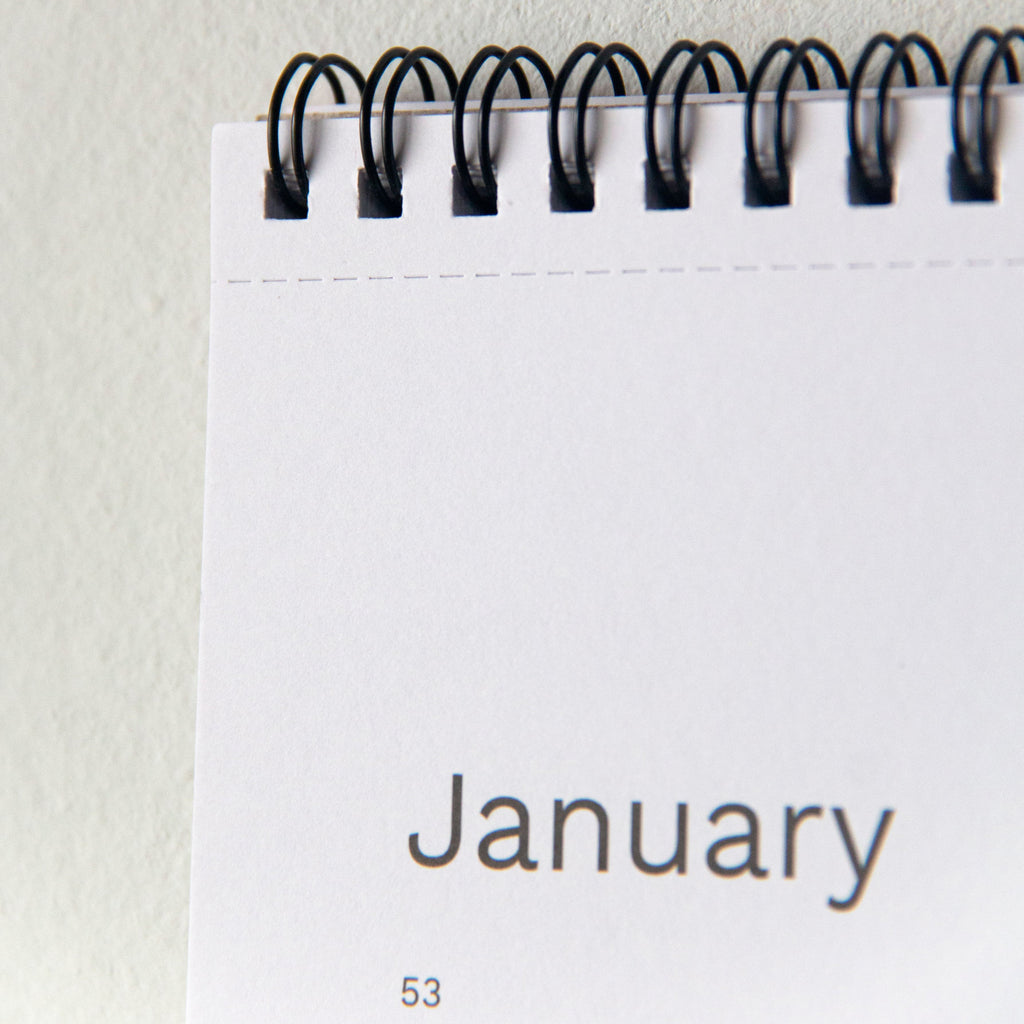 2027 wall planner by Octàgon Design. Detail of the spiral ring and the cut mark for easy removal of each month.