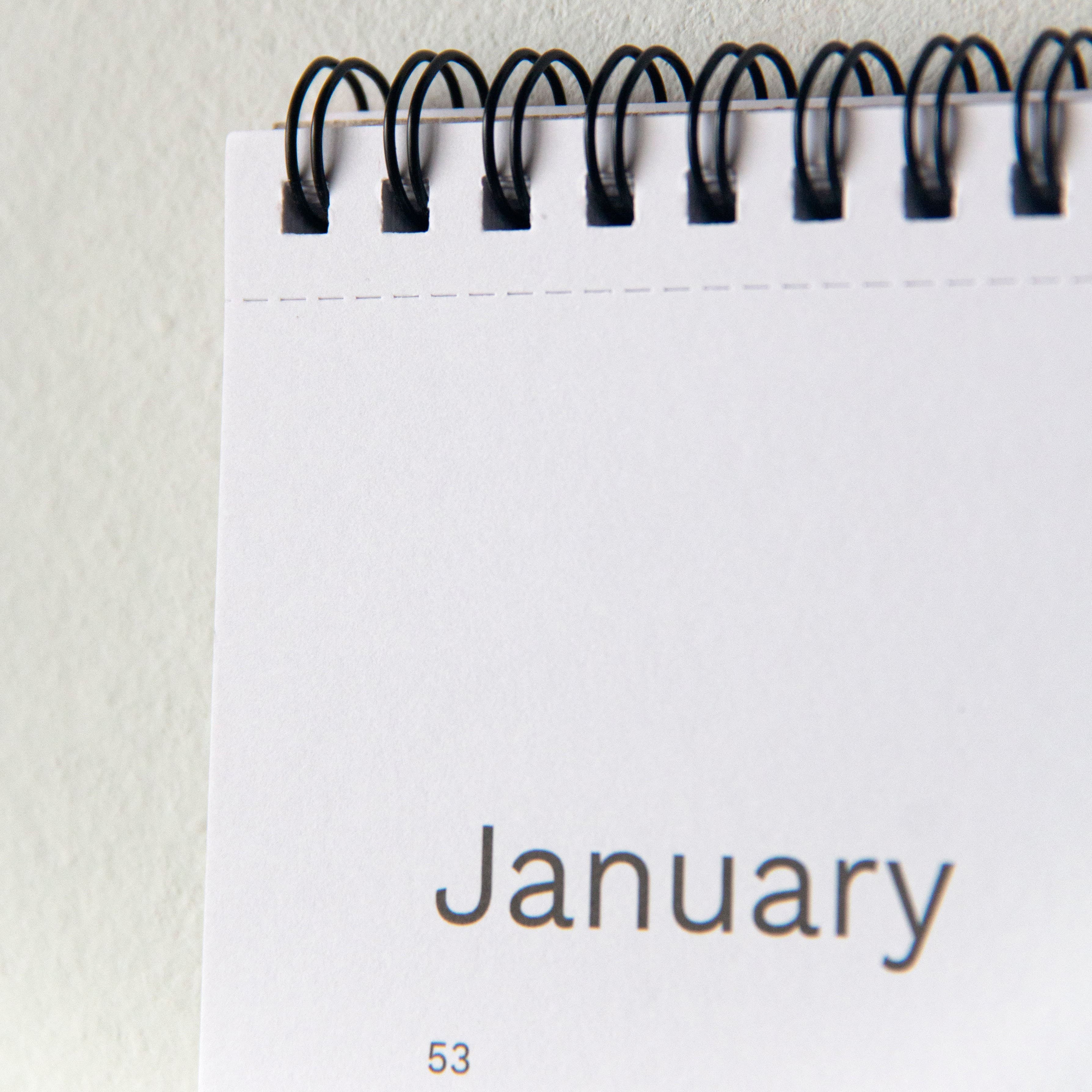 2027 wall planner by Octàgon Design. Detail of the spiral ring and the cut mark for easy removal of each month.