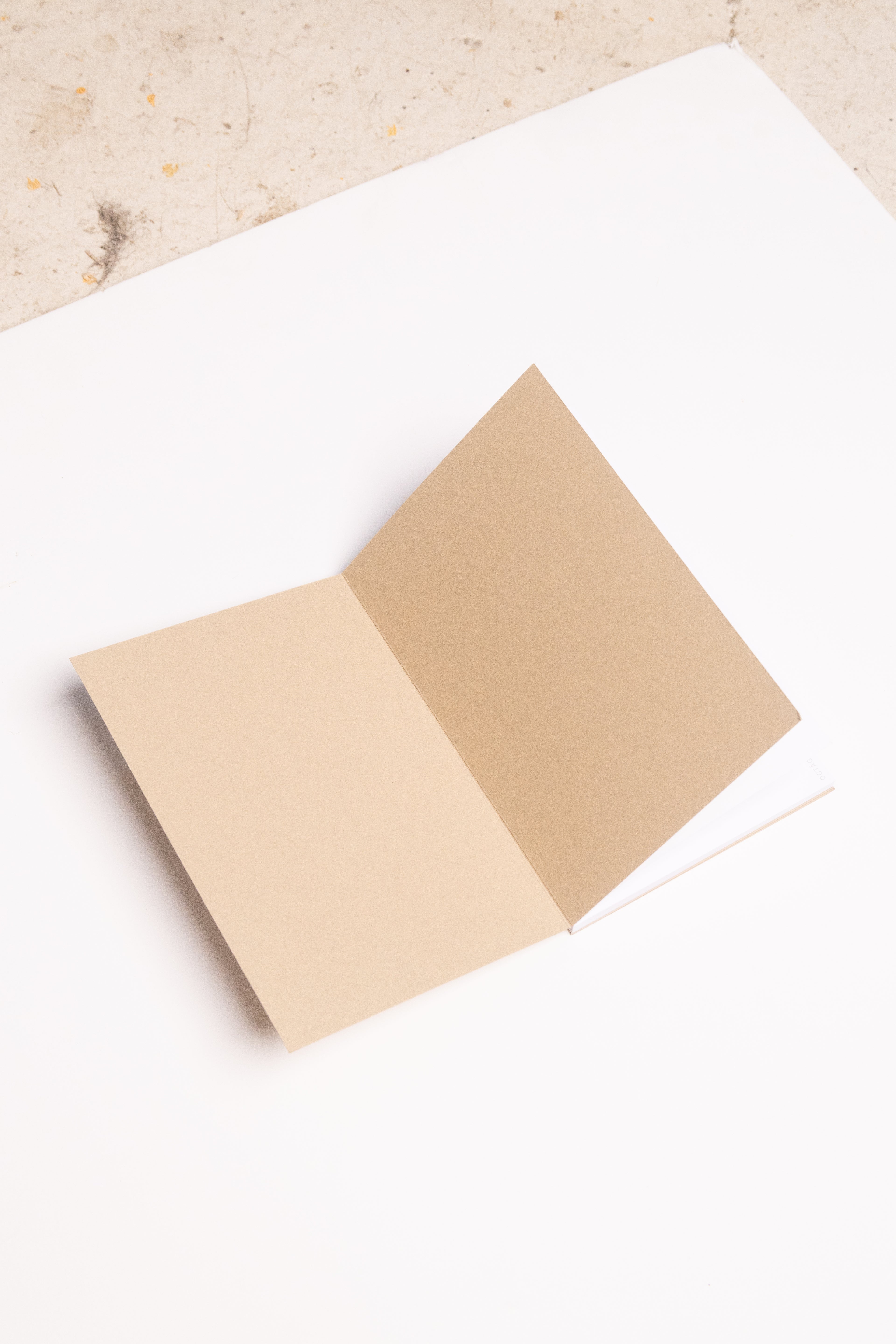 Open Spine Notebook 13,5x20 cm (80 pages) · Dotted. Lay-flat opened notebook. Inner cover detail. Camel color.