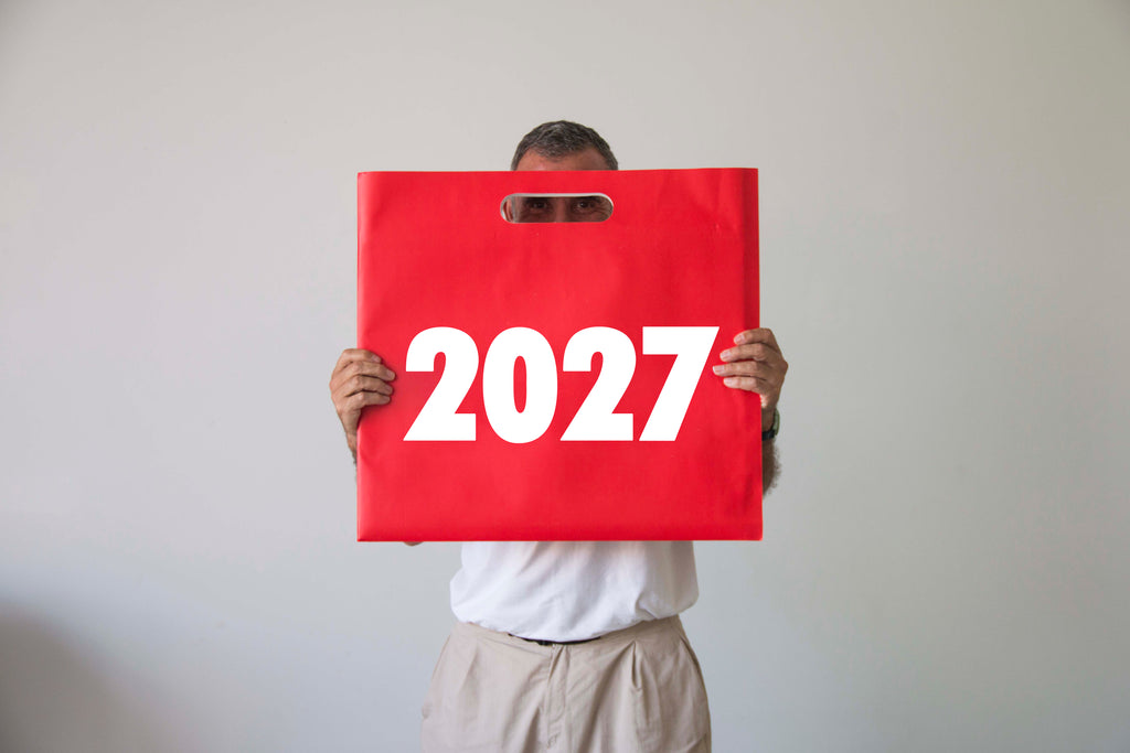 2027 Vinçon wall Calendar by Octàgon Design. A man holding the bag of the Vinçon Calendar.