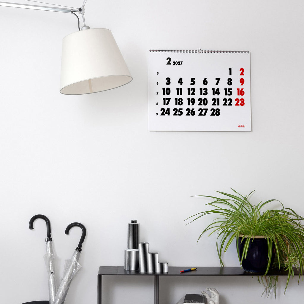 2027 Vinçon wall Calendar by Octàgon Design. The calendar holding on a white wall. Home atmosphere.