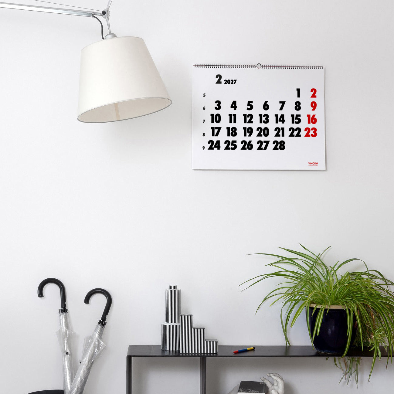 2027 Vinçon wall Calendar by Octàgon Design. The calendar holding on a white wall. Home atmosphere.