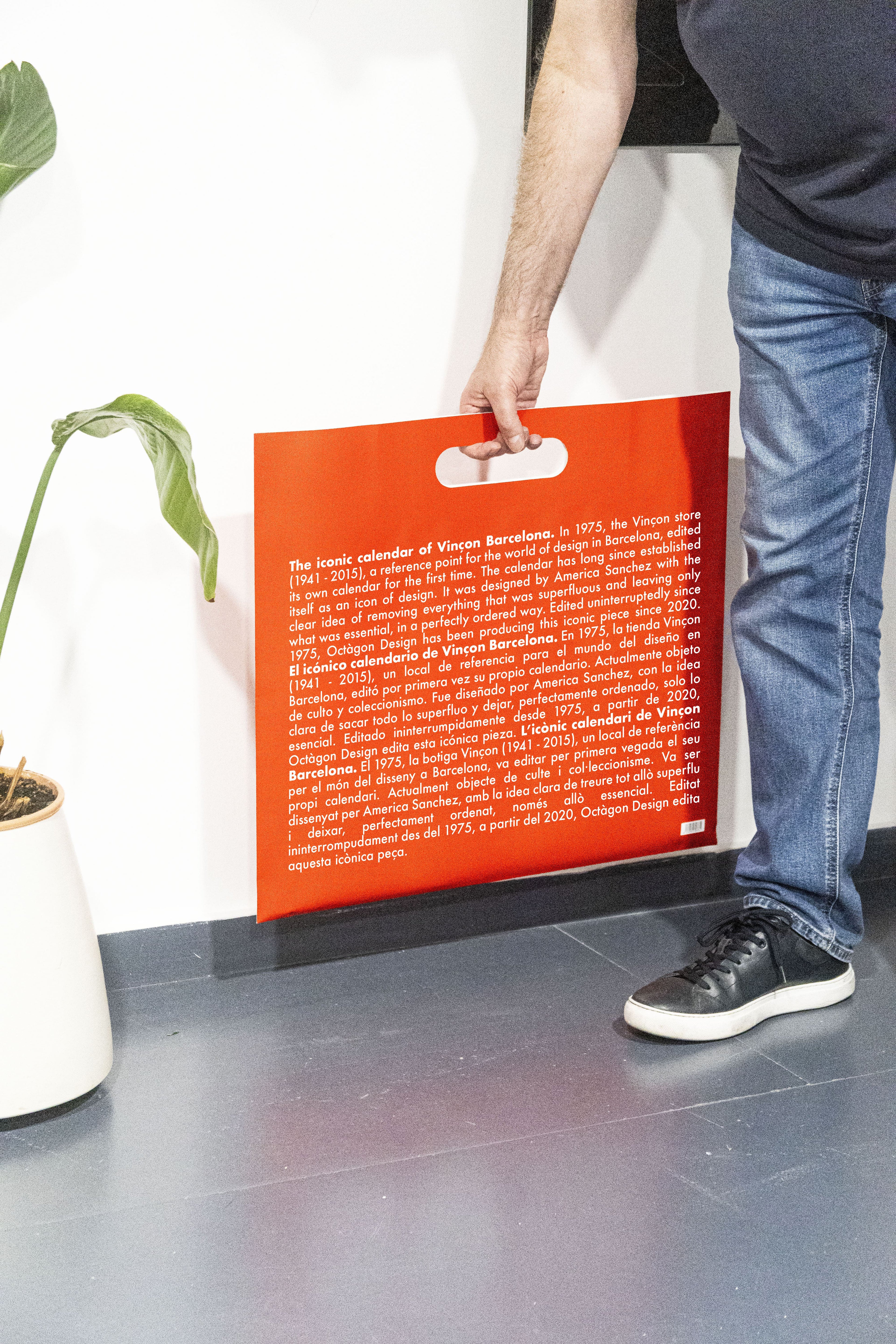 2027 Vinçon wall Calendar by Octàgon Design. A man holding the bag of the Vinçon Calendar.
