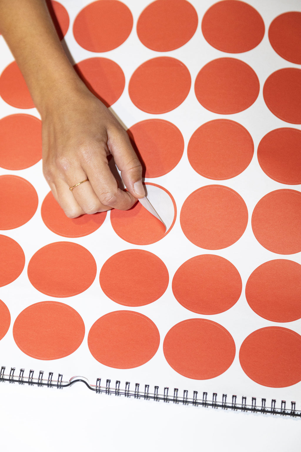 2027 Vinçon wall Calendar by Octàgon Design. Page with round red stickers so you can mark local holidays or personal dates.