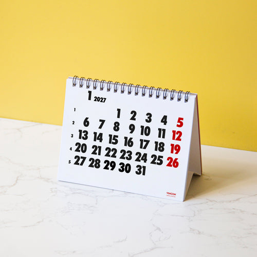 2027 Vinçon desk calendar by Octàgon Design. The calendar on a table.