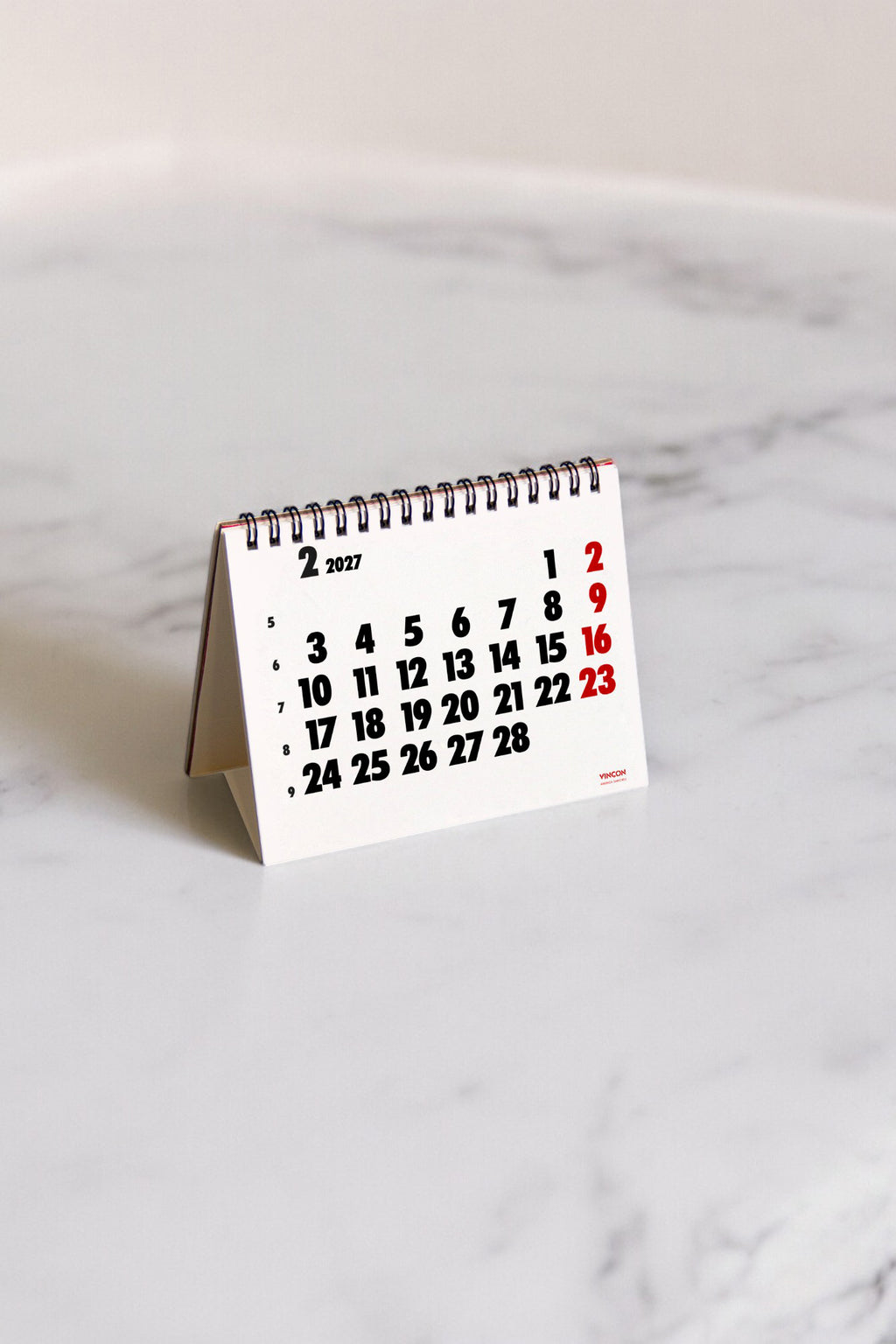 2027 Vinçon desk calendar by Octàgon Design. The calendar on a table.