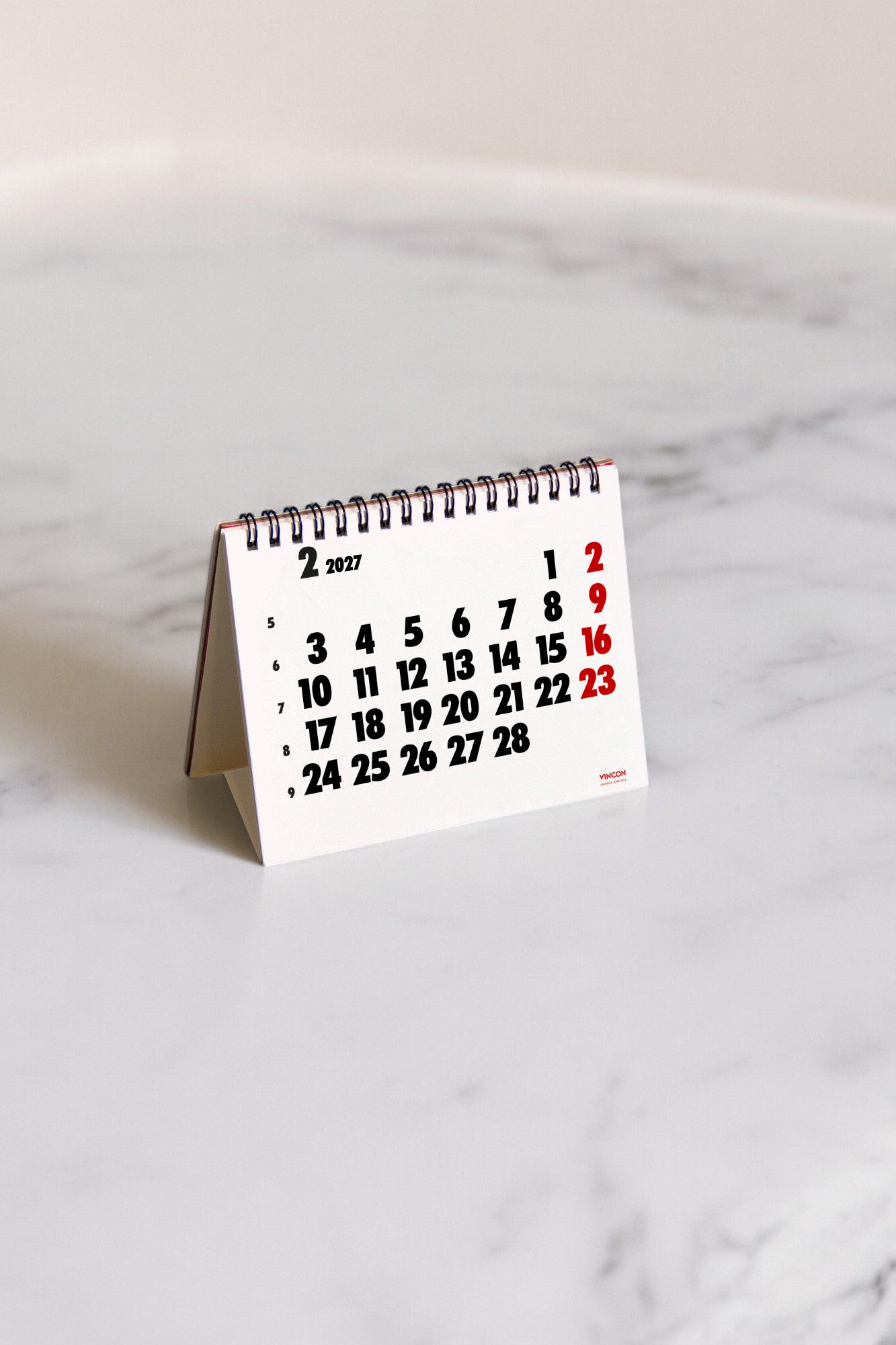 2027 Vinçon desk calendar by Octàgon Design. The calendar on a table.