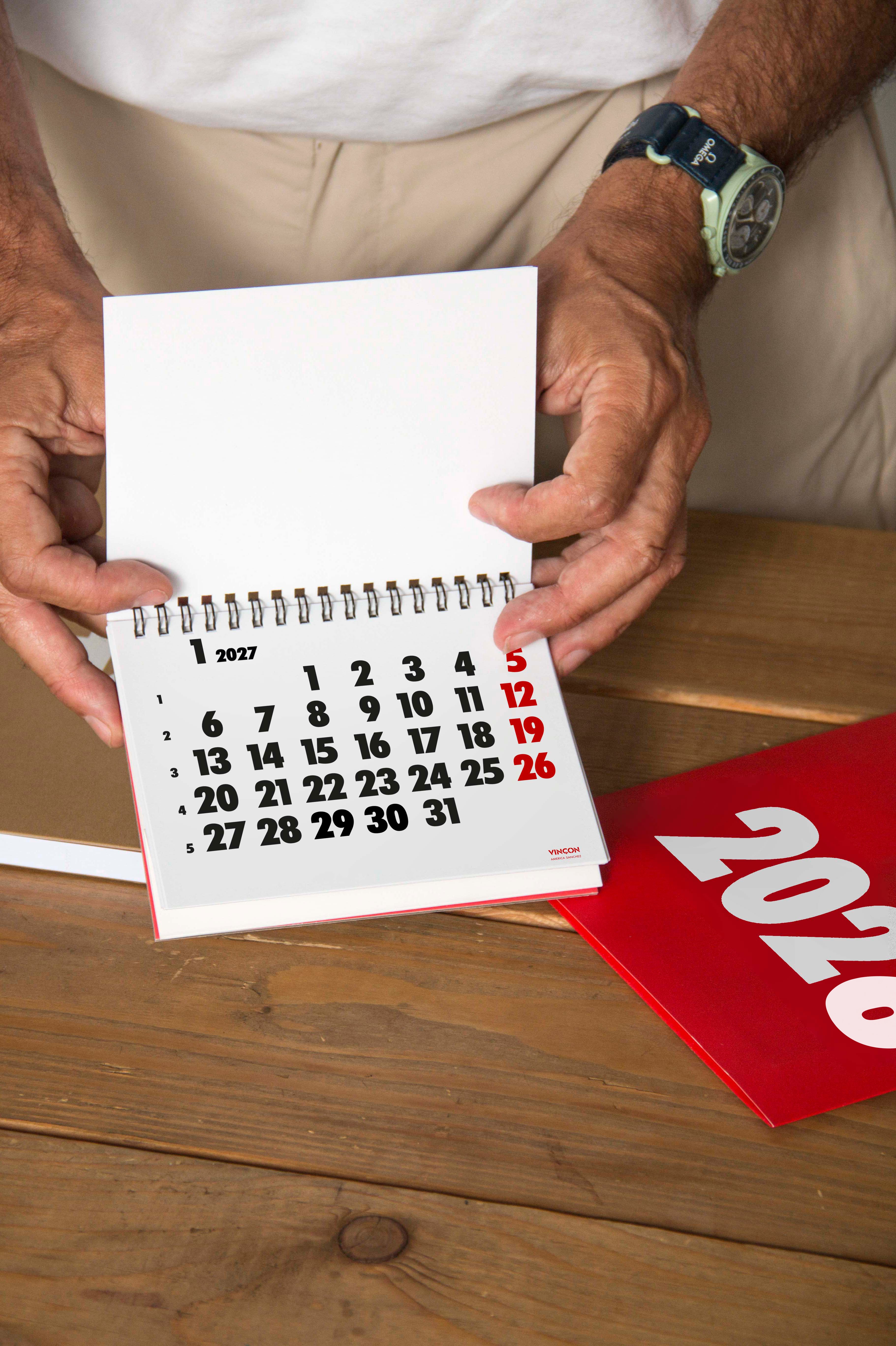 2027 Vinçon desk calendar by Octàgon Design. A man showing the January page.