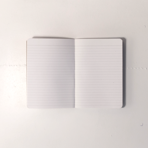 Open "Write" lined notebook on a white background. | Cuaderno de rayas "Write" abierto sobre un fondo blanco. | Llibreta de ratlles "Write" oberta sobre un fons blanc