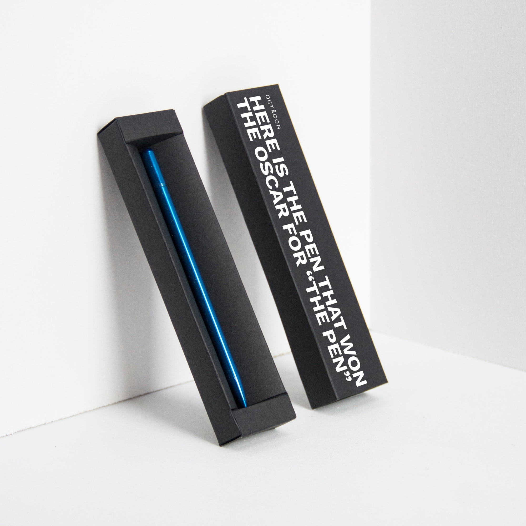 OCTÀGON DESIGN | &quot;Drop Pen&quot; metallic blue color pen and black pen box with &quot;Here is the pen that won the Oscar for &quot;THE PEN&quot; print white colour.