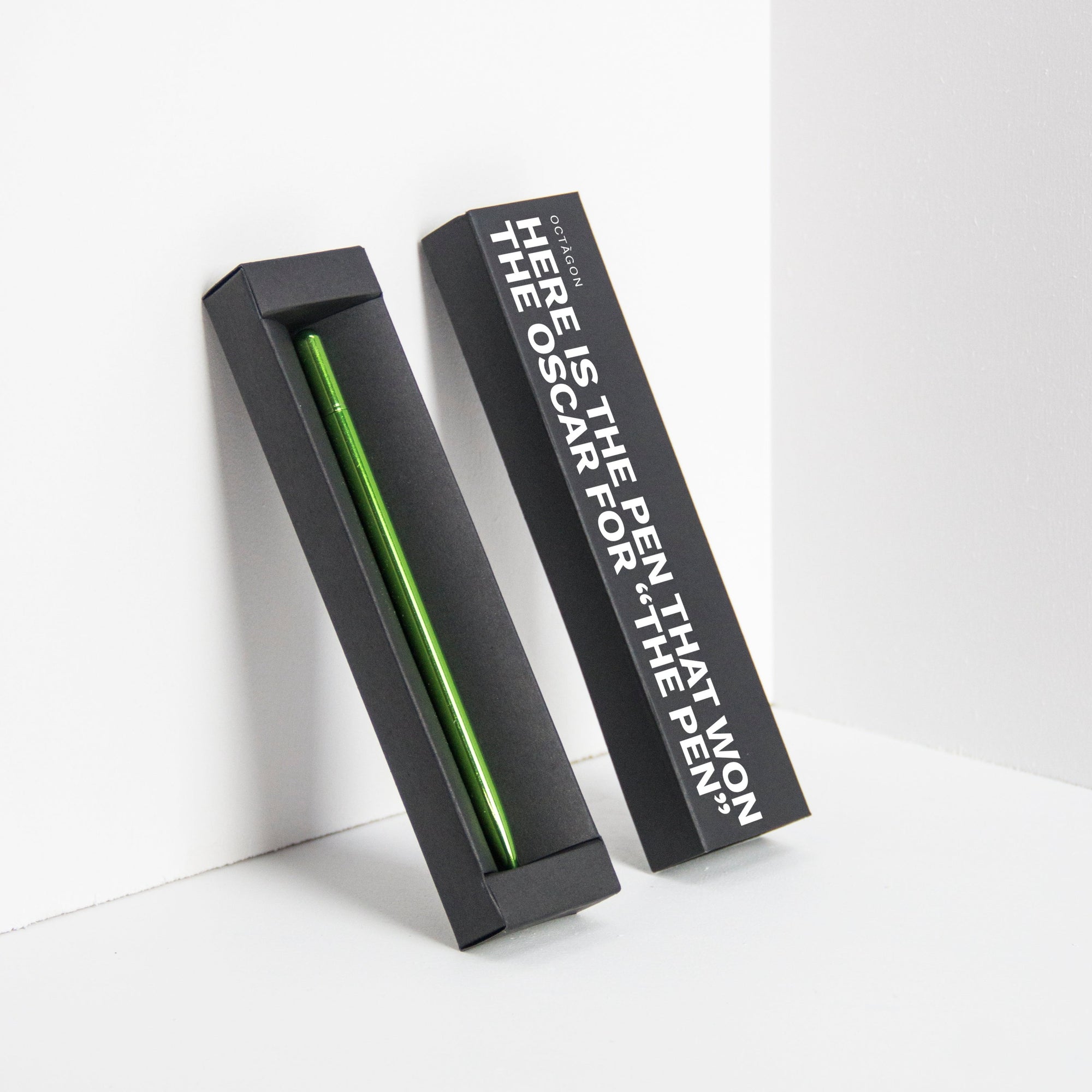 OCTÀGON DESIGN | "Drop Pen" metallic green color pen and black pen box with "Here is the pen that won the Oscar for "THE PEN" print white colour.