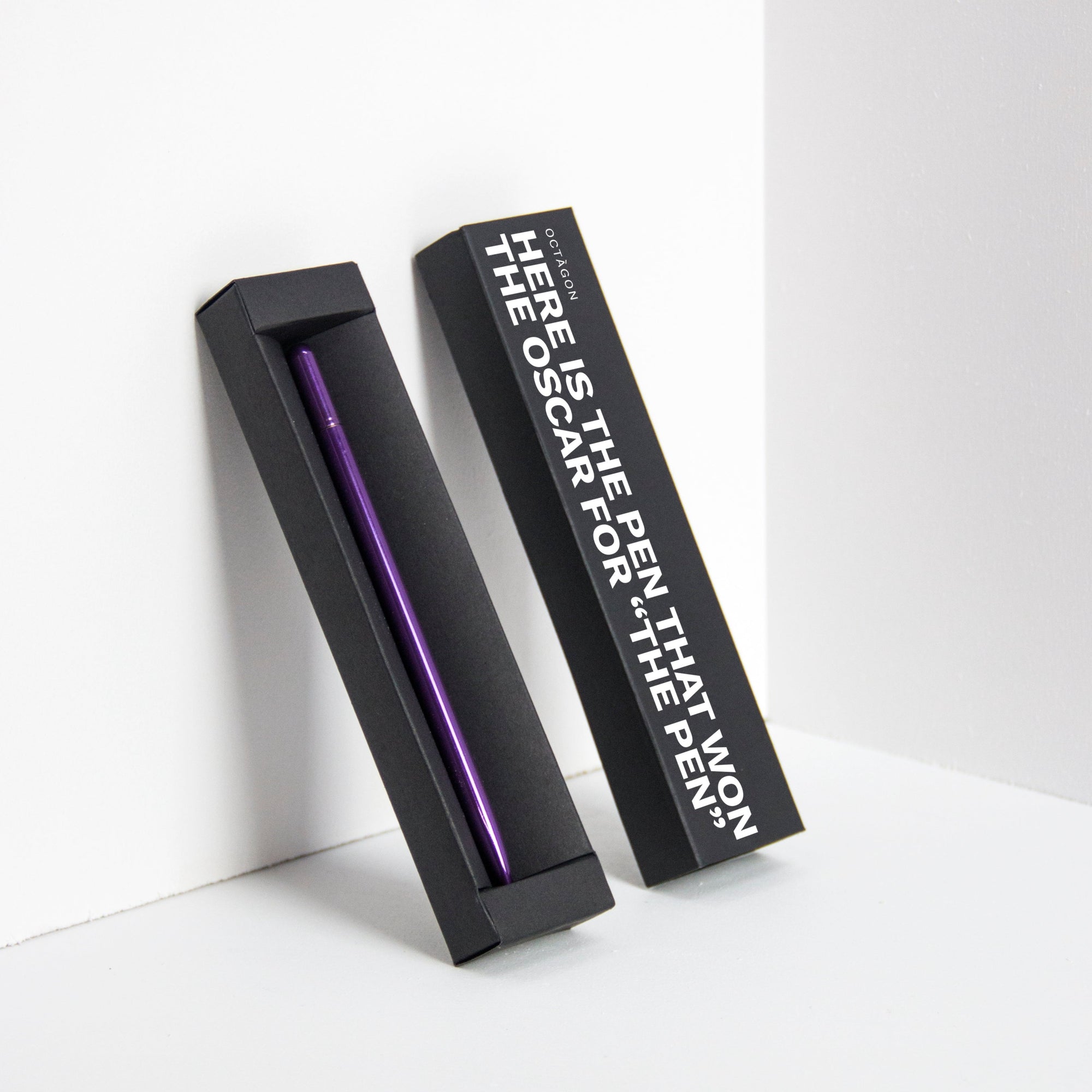 OCTÀGON DESIGN | "Drop Pen" metallic purple color pen and black pen box with "Here is the pen that won the Oscar for "THE PEN" print white colour.