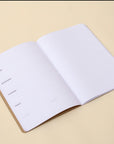 Open "Planner" weekly planner, the left page is a weekly template and the right page is ruled for notes.| OCTÀGON DESIGN 