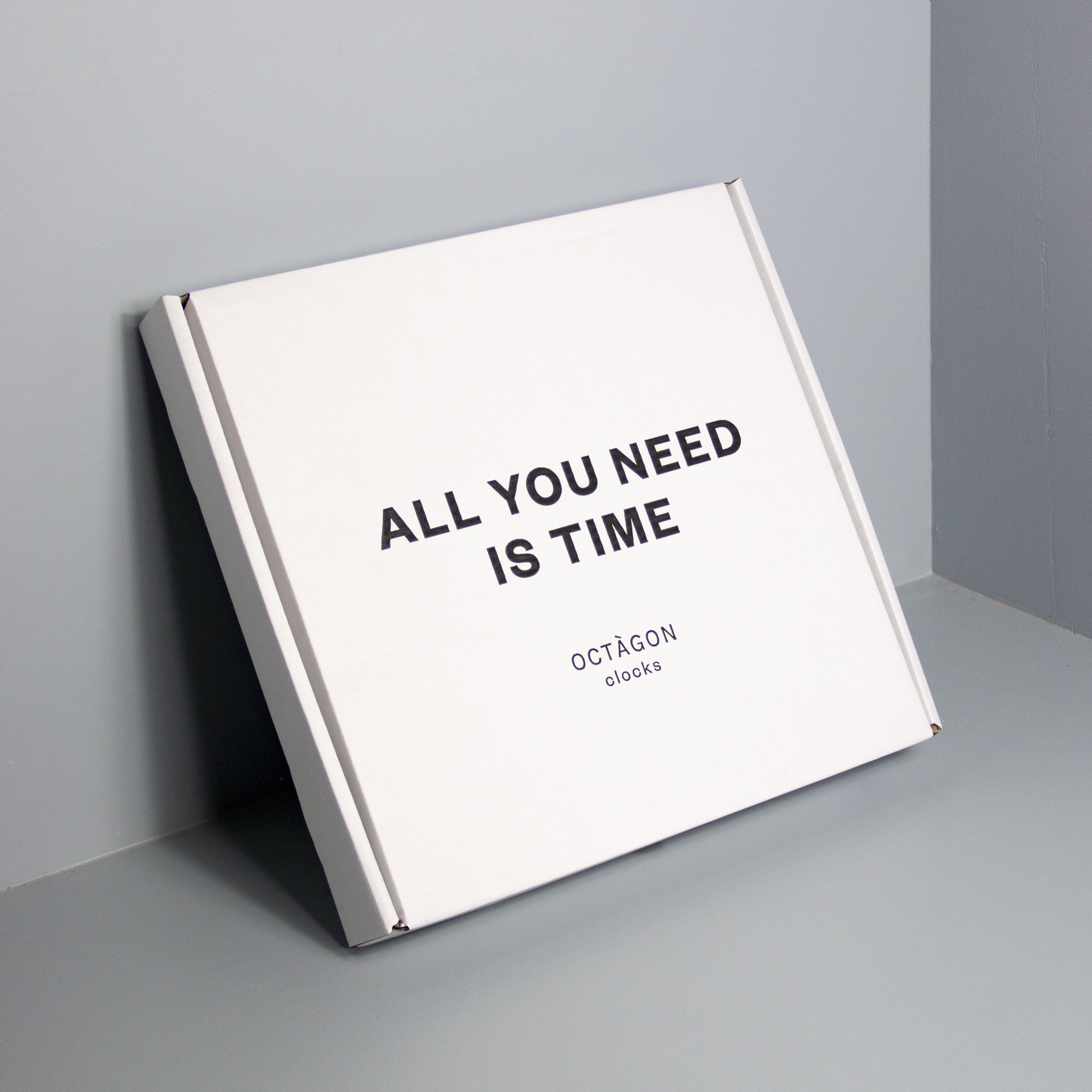 White clock box with &quot;All you need is time&quot; print black colour.