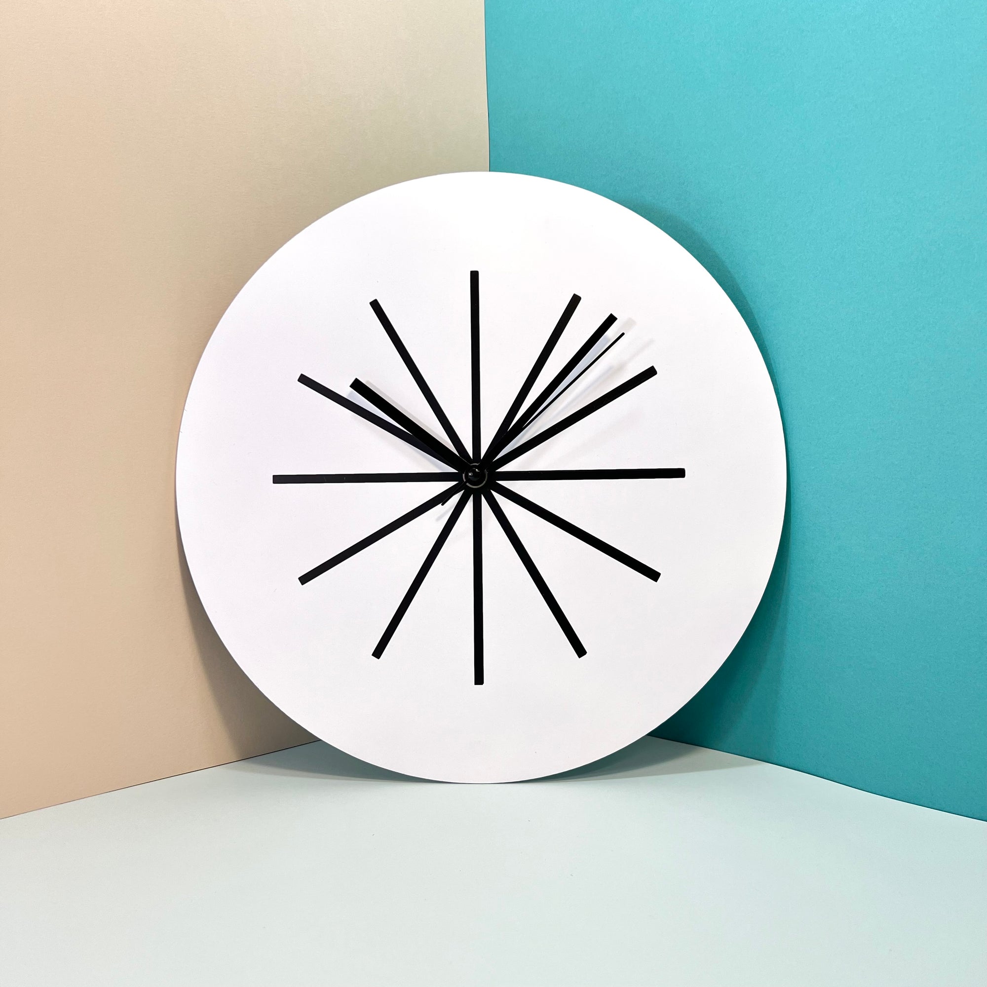 "Modern" wall clock. White and black base, clock hands black colour.