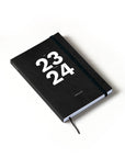 OCTÀGON DESIGN | Sep23 to Aug24 Academic weekly planner, black color, white typography with an elastic closure band.