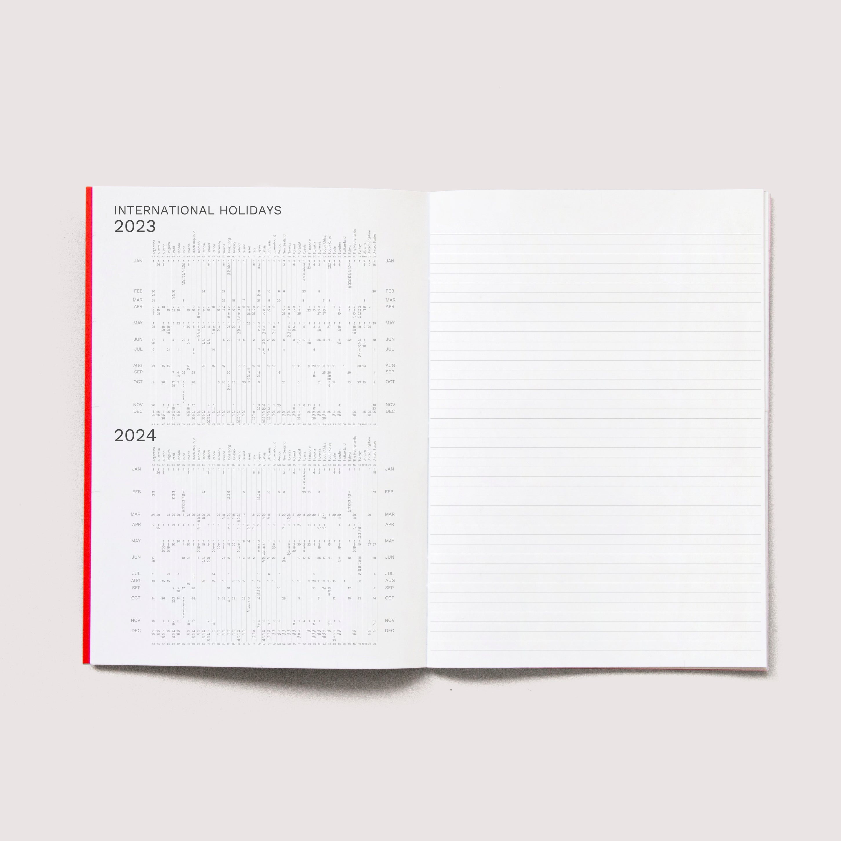 OCTÀGON DESIGN | Open &quot;Sep23 to Aug24&quot; Academic monthly planner. International holidays 2023 and 2024 on the left page and a lined template for notes on the right page.