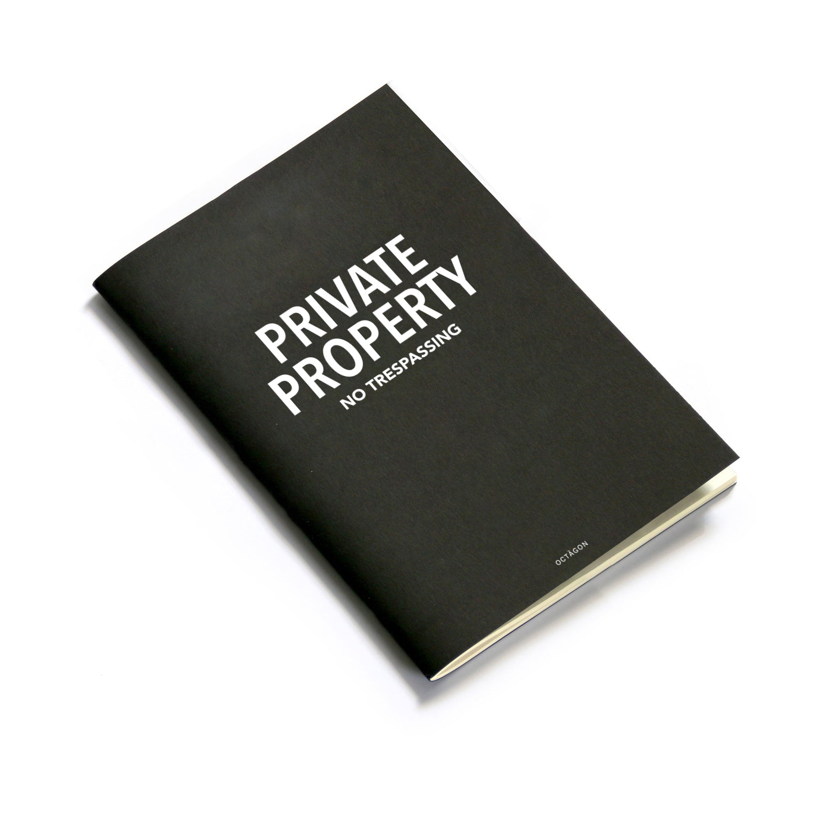 "Private property" thin notebook. Cover black color and white typography.