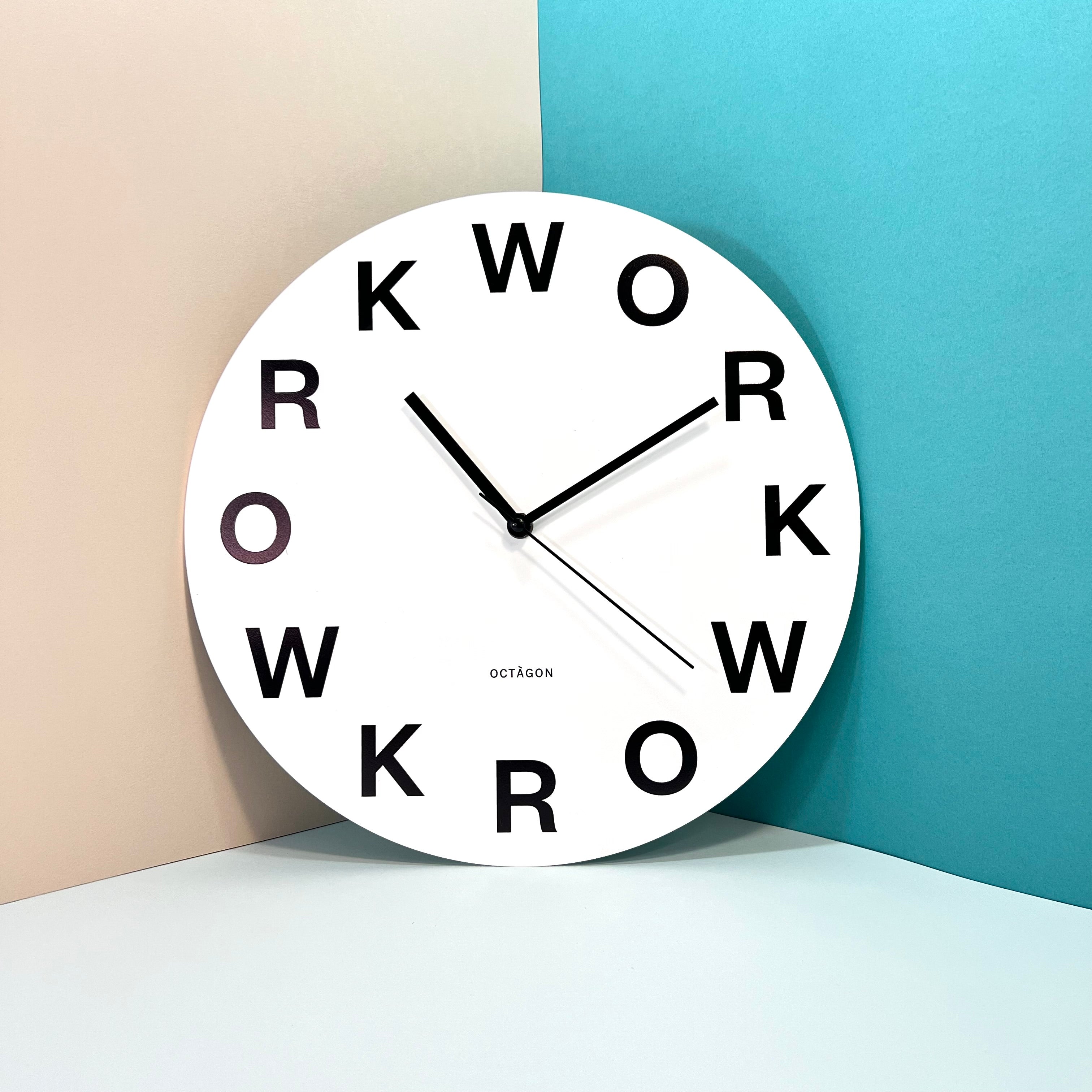 "Work" clock on a colored wall | Reloj "Work" en una pared de colores. | Rellotge "Work" en una paret de colors.